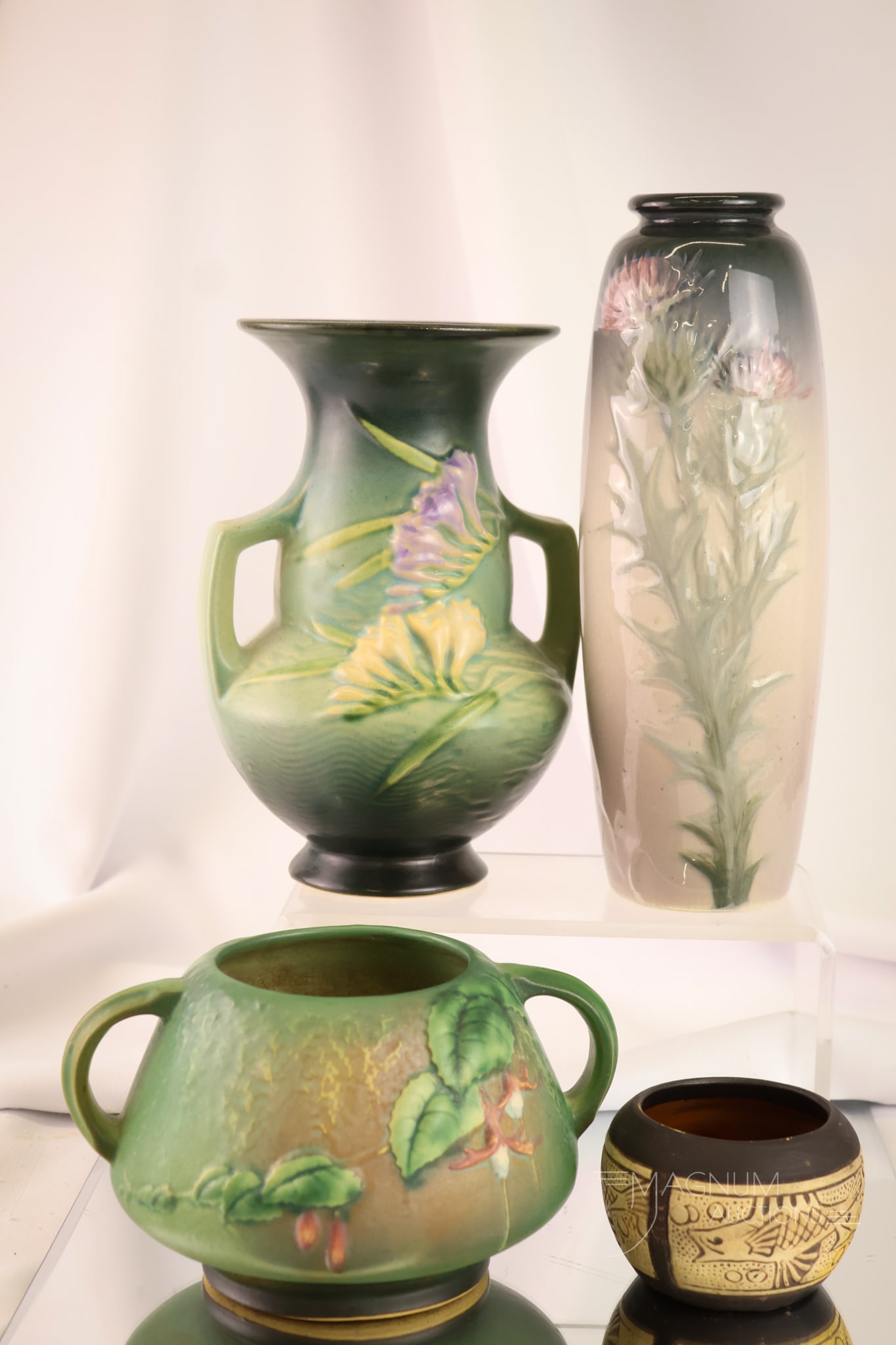 4 pc Lot American Art Pottery Roseville & Weller: Four selections in American Art Pottery that are sure to please. The first and second are Roseville examples with fuchsia and freesia decoration. The next two vases are Weller. There is a Burntwood va