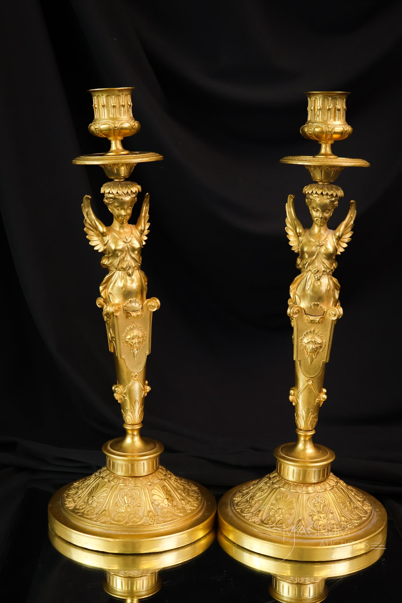 Pair of Neoclassical Gilt Bronze Figural Candlesticks: Fine pair of gilt bronze Neoclassical winged figural candlesticks. These are Empire and may be French in origin. Each measures 13 1/2" tall and 5 1/4" wide.