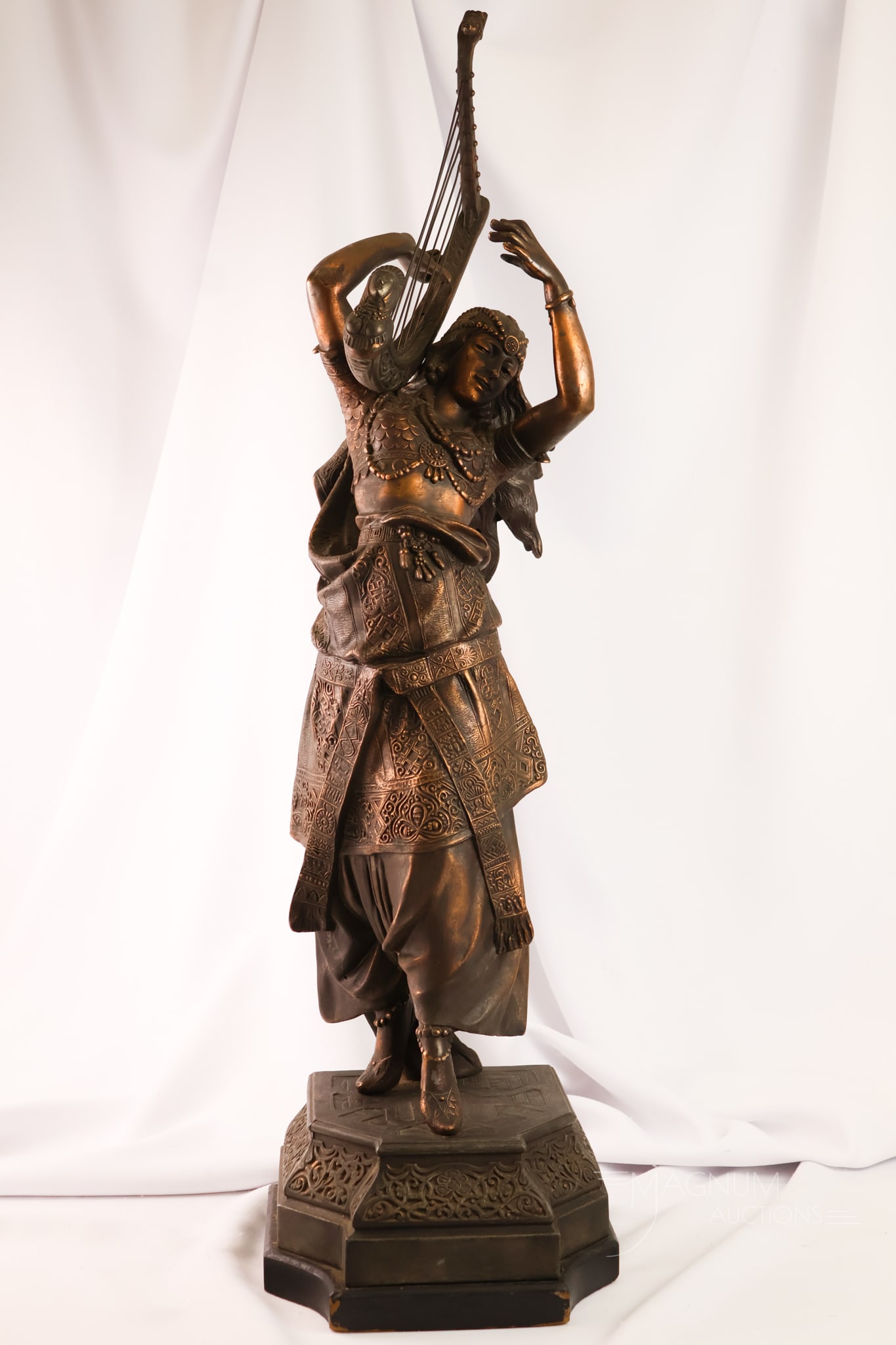 Monumental 34" 19th Century Spelter "Girl with Harp" by Arthur Waagen Statue: A beautiful 19th-century spelter statue titled "Girl with Harp" by Arthur Waagen. The piece features an orientalist-style figure dancing with a harp. The piece measures 34" tall and 9 1/2" wide.