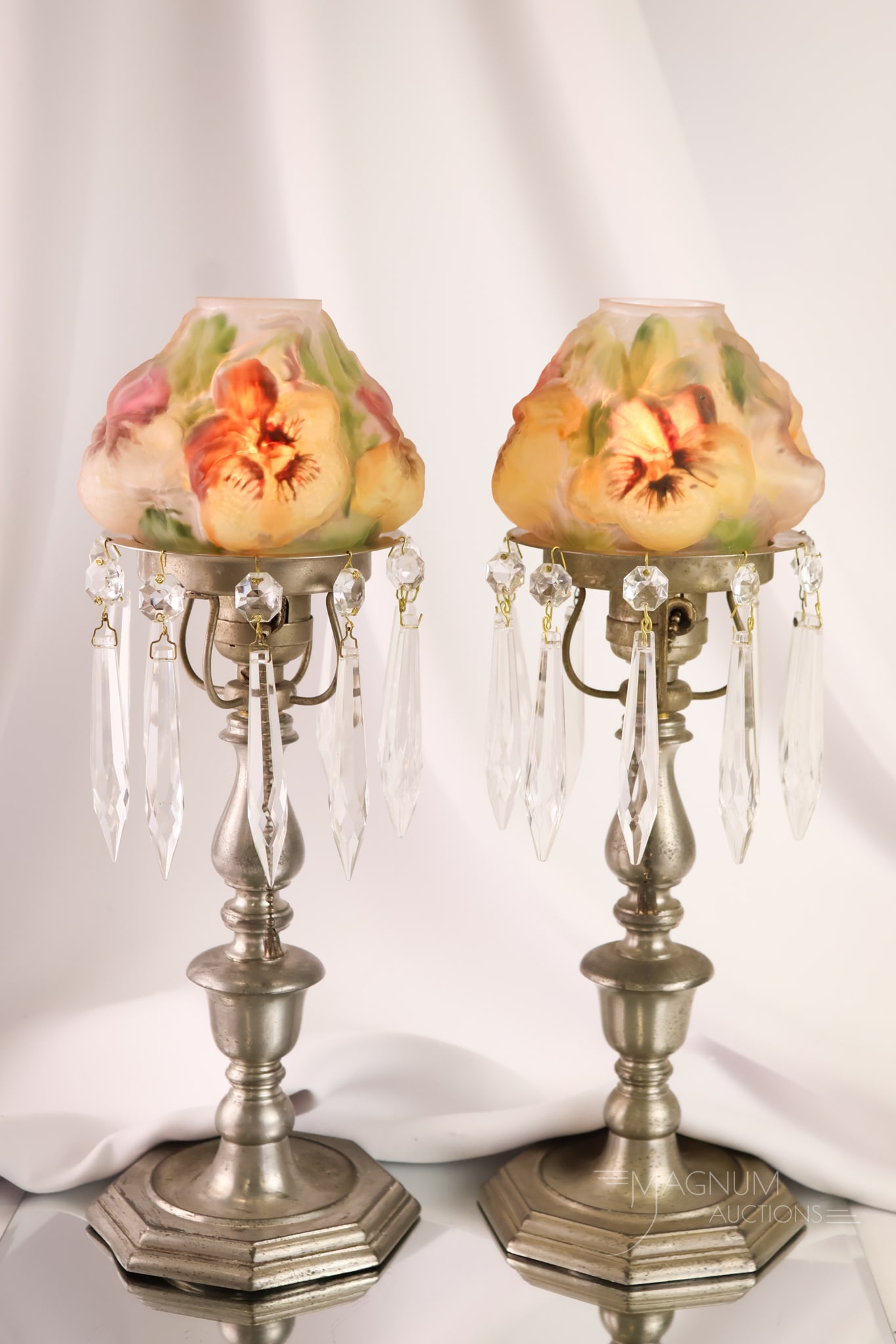 Rare Pair Pairpoint Puffy Electric Boudoir Lamps: A rare find in Pairpoint Miniature lamps. These are a pair of Pairpoint puffy Pansy flower electric lamps. The pair has silverplate bases with prisms around the shade holder. Each lamp measures 12