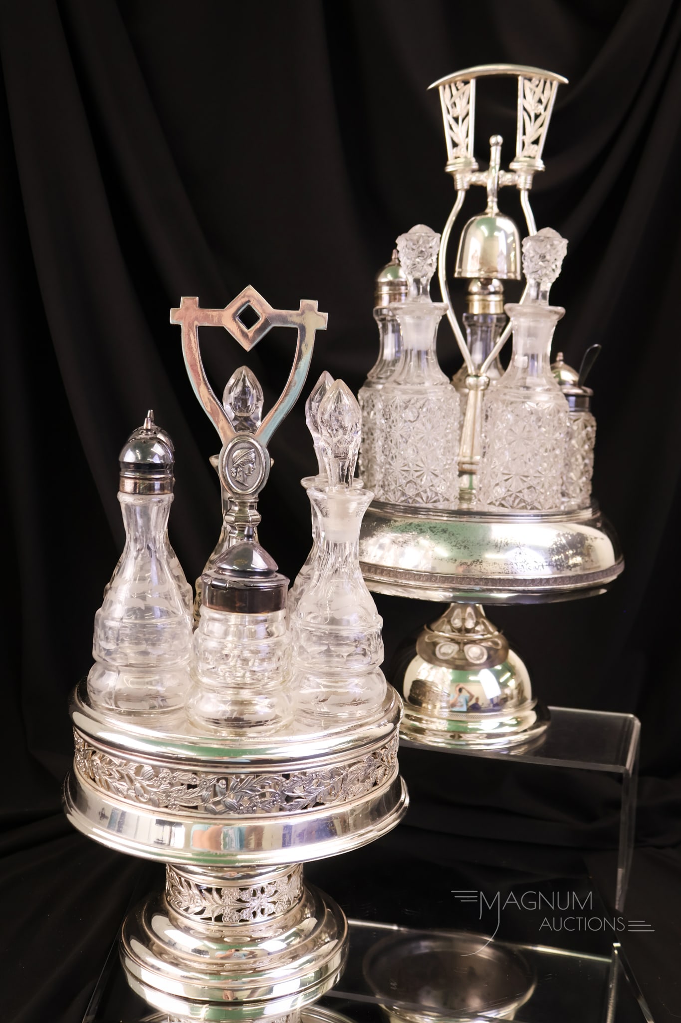 2 pc Lot Rogers Rockford Victorian Silverplate & Glass Condiment Castors: Two beautiful examples of Victorian silverplate and glass condiment castors. One is signed Rockford, and one is signed Rogers. Each has a set of six castor bottles. The Rockford holder features a