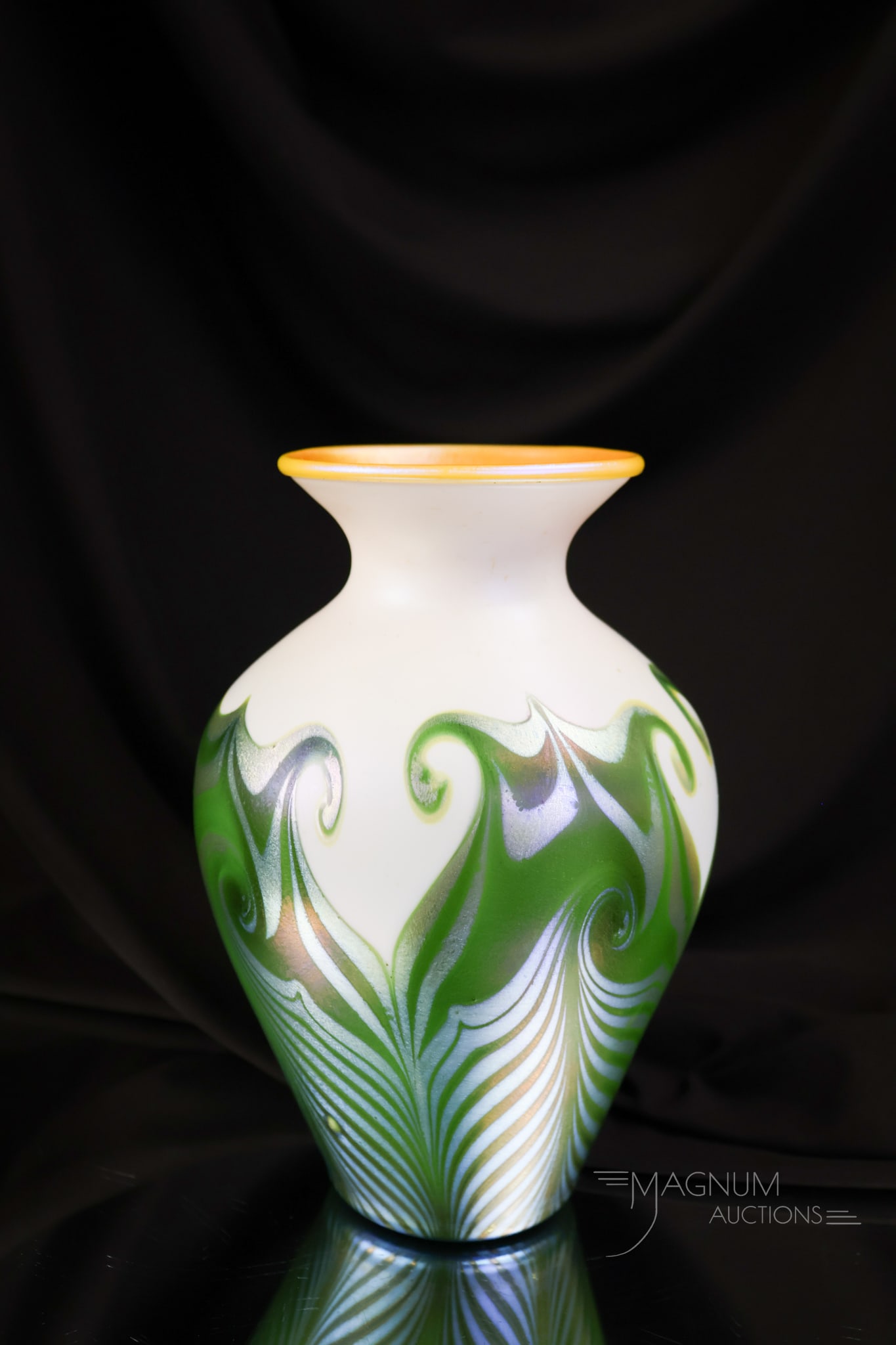 Signed Quezal Hooked Feather Iridescent Glass Vase: A fine signed Quezal Hooked Feather-decorated vase. This vase features green and blue feathers and a gold iridescent interior. The vase measures 7" tall and 4 1/2" wide.