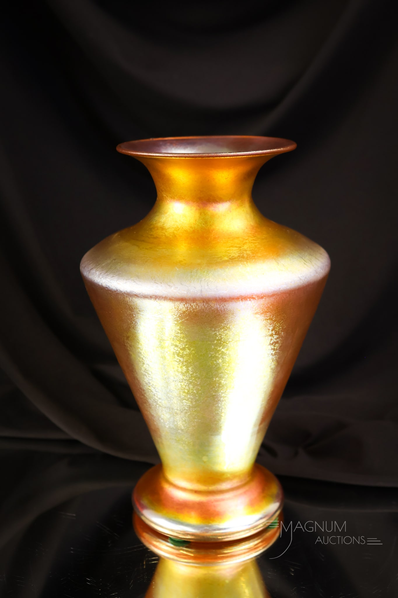 Signed Durand Gold Iridescent Glass Vase: One of the best color pieces of gold iridescent Durand you will find. This vase is signed Durand. It features a shouldered and flared rim. The vase measures 8 1/2" tall.