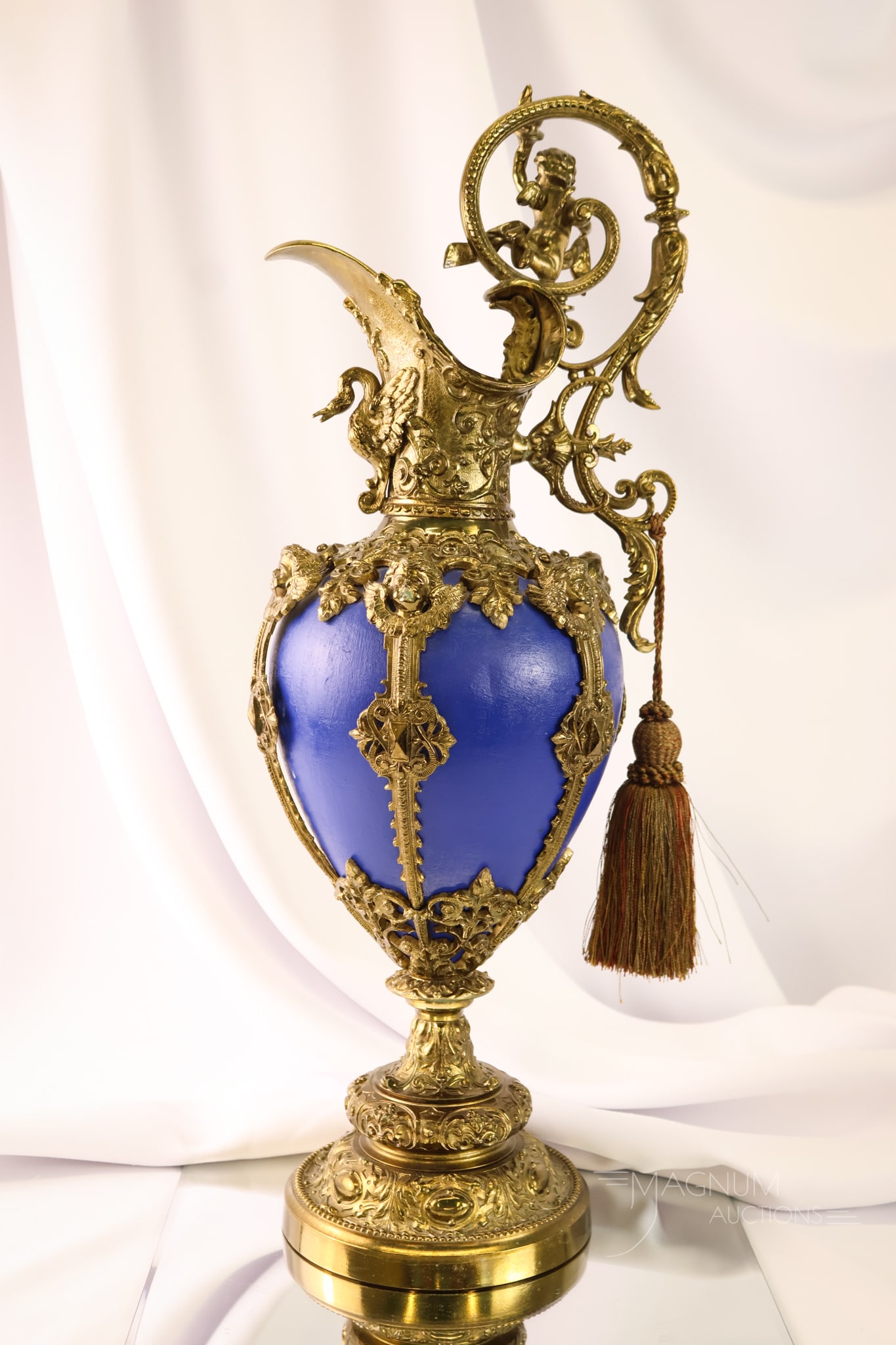 French Baroque Style Gilt Bronze 23" Mantle Ewer with Cobalt Body: A beautiful French Baroque-style gilt bronze with cobalt body mantle ewer. This piece measures a sizeable 23" tall and 9" wide. The metal features a relief design of cherubs, swans and more.