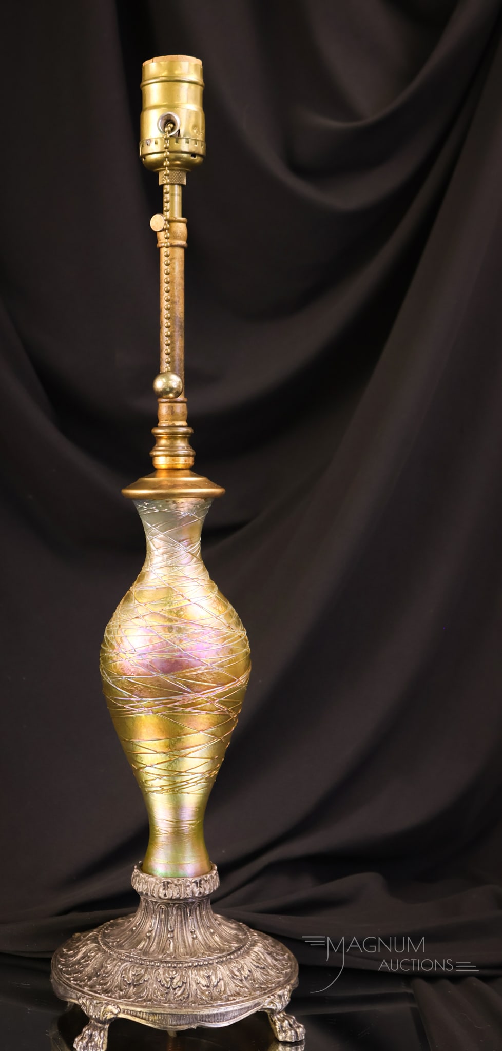 Durand Gold Iridescent Glass Threaded Table Lamp: A beautiful Durand gold iridescent glass threaded vase lamp base. This piece features a classic form and nice coloring. Some of the hardware is not period to the lamp. The lamp measures 20 1/4" tall.