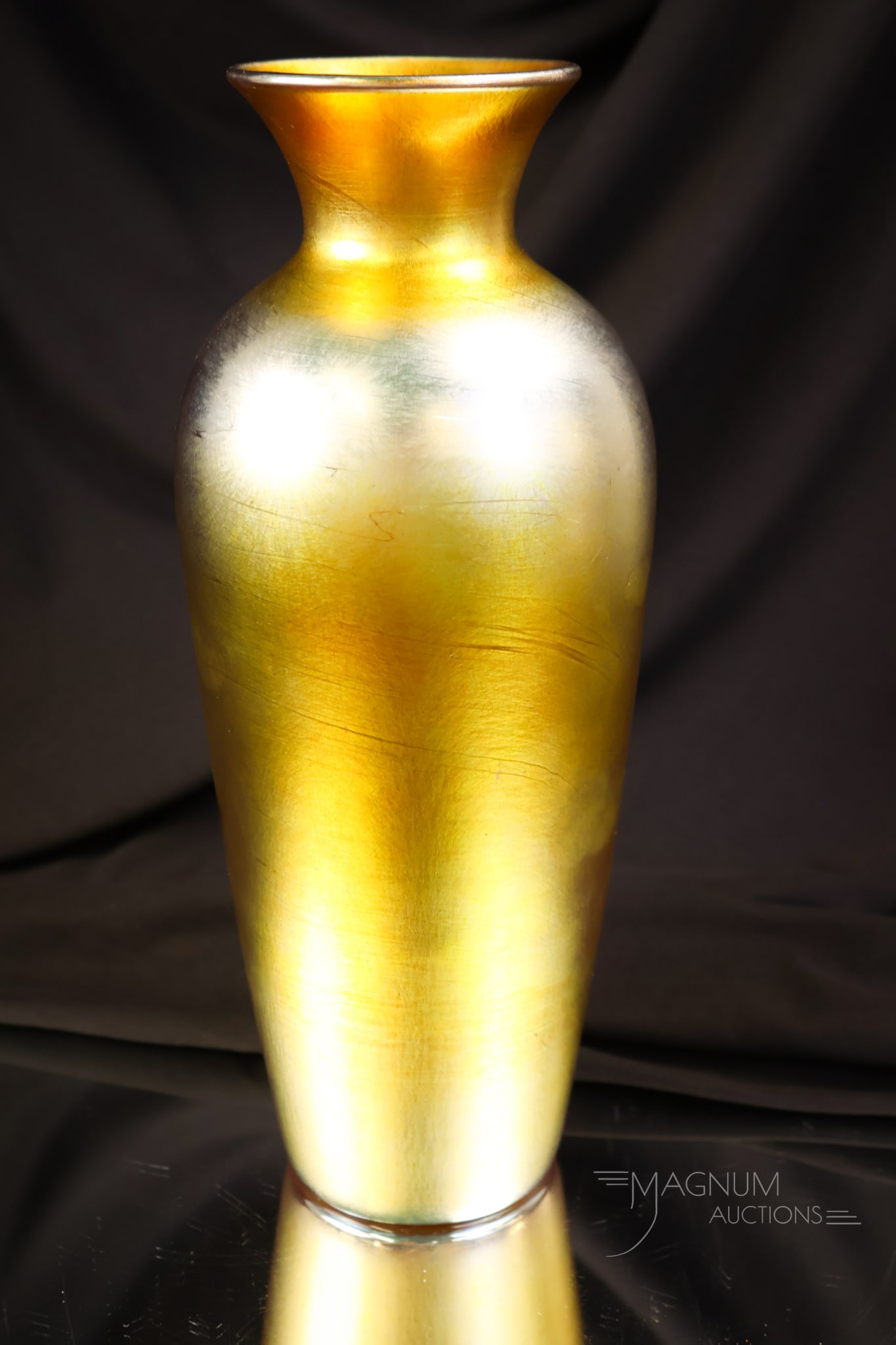 Unmarked Durand Gold Iridescent Art Glass Vase: A fine offering for your bidding pleasure. This is an unmarked gold iridescent Durand vase. This vase measures 11" tall and 4" wide.