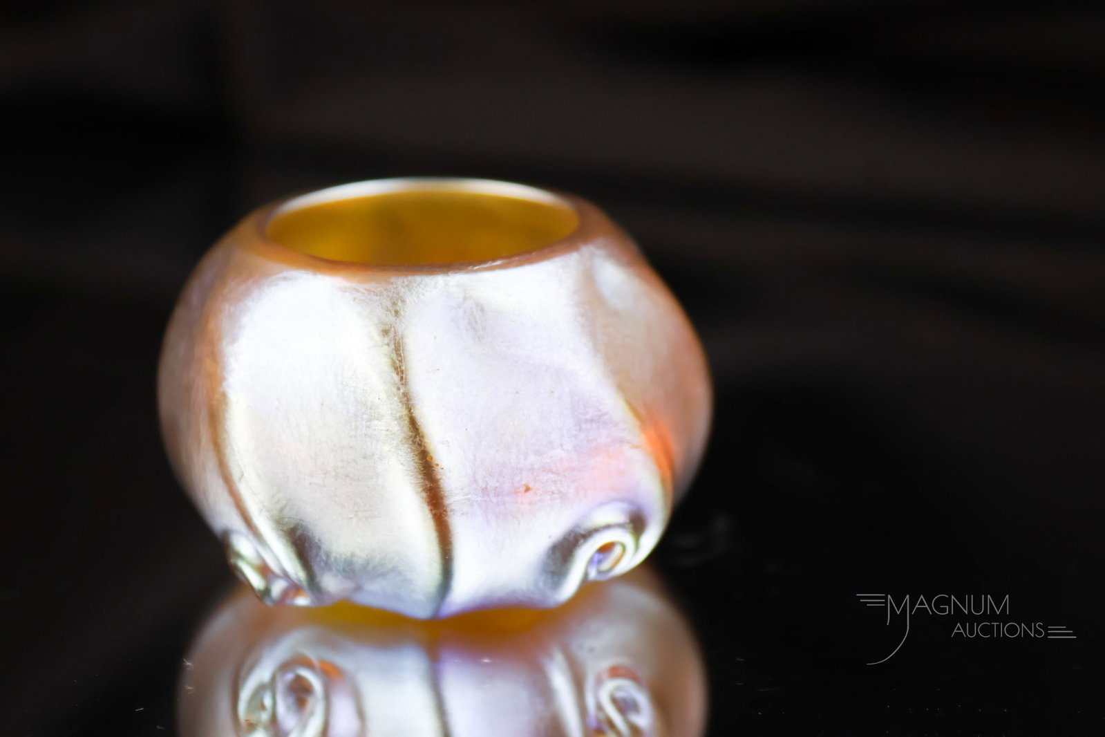 Signed Tiffany Favrile Gold Iridescent Art Glass Open Salt: A signed "L.C.T. 2604" Tiffany gold Favrile pigtail open salt. This piece has rich iridescence and great form. The salt measures 1" tall and 1 3/4' wide.