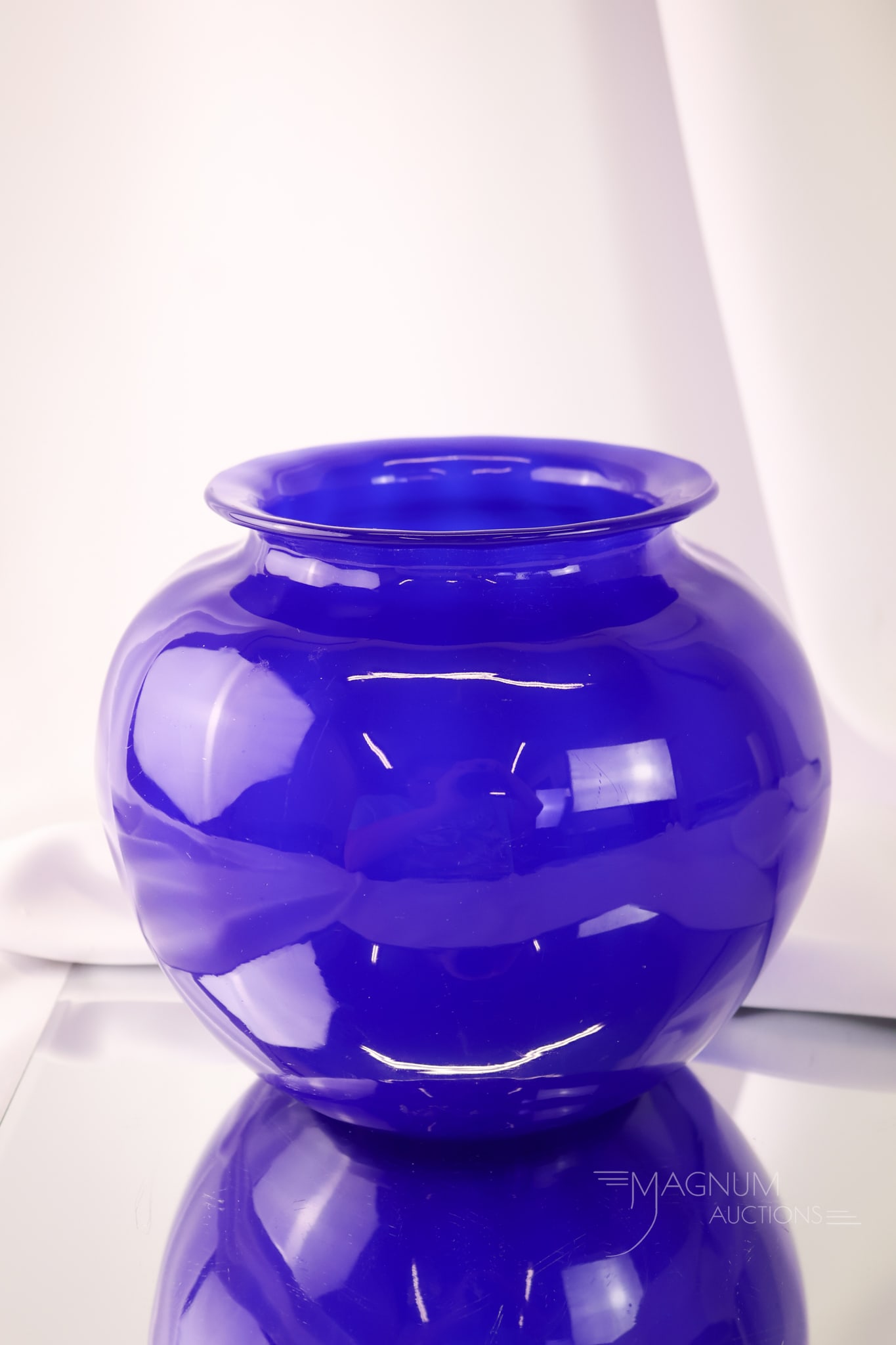 Steuben Dark Blue Jade Art Glass Vase: A dark blue Steuben Jade bulbous art glass vase. This piece is marked with an acid-etched stamp. The vase measures 7" tall and 8" wide.