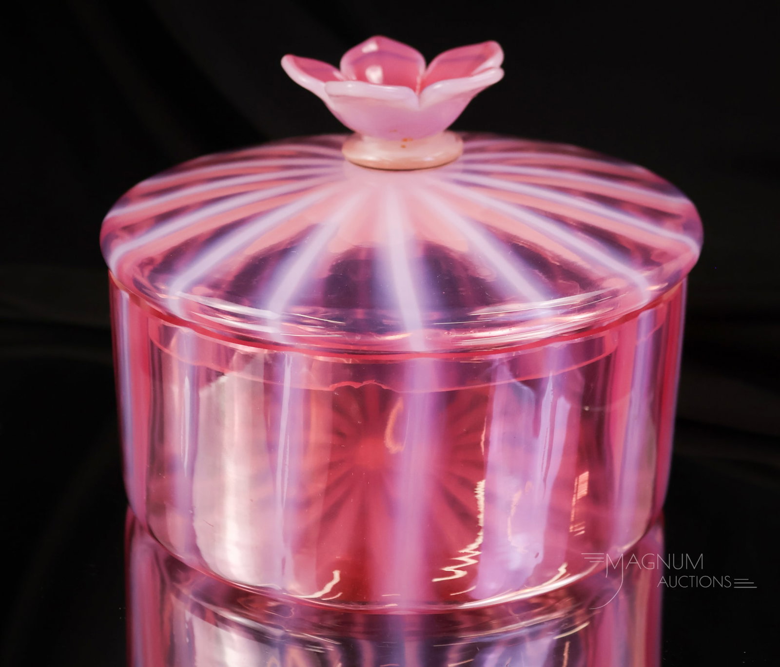 Steuben Oriental Poppy Opalescent Art Glass Puff Box: A beautiful oriental poppy Steuben puff box with flower finial. The box is numbered #7540. The box measures 4" tall and 5 1/2" wide. The lid flange exhibits a rim chip as shown.