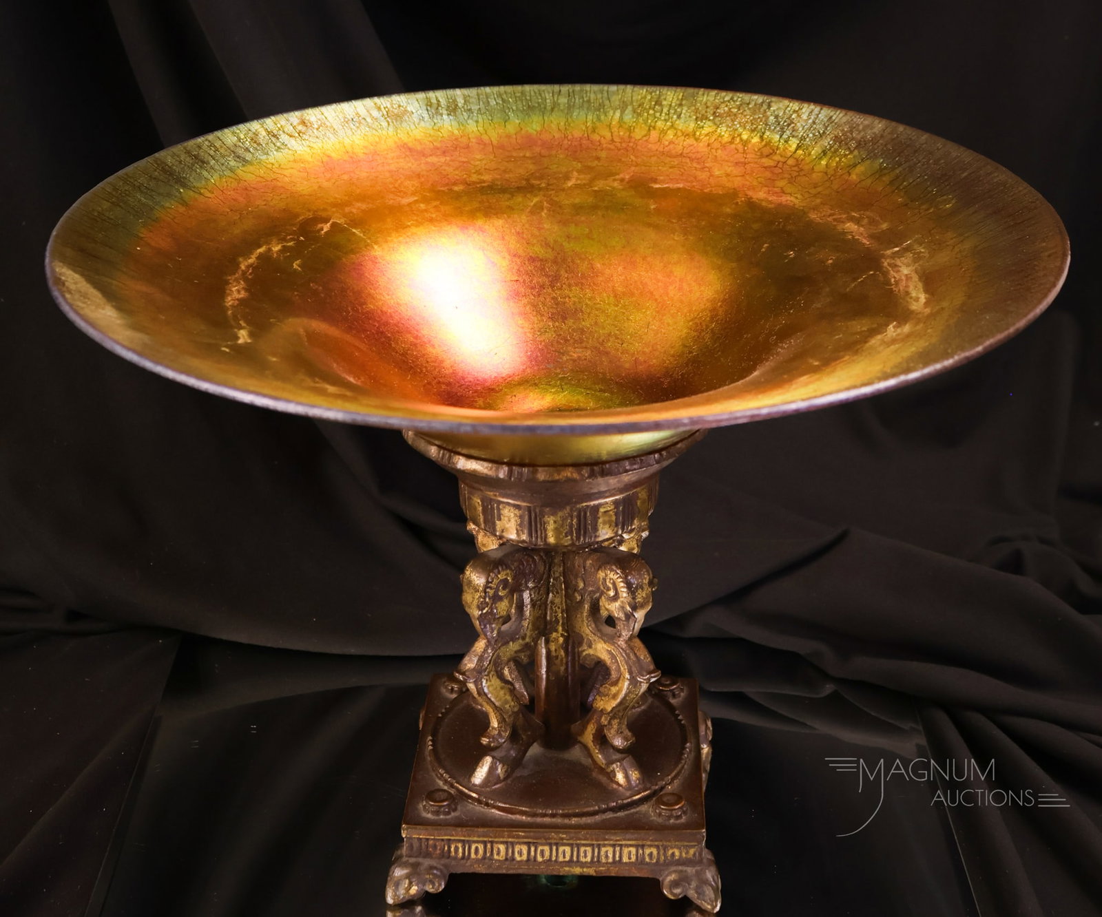 Oscar Bach & Steuben Gold Aurene Art Glass Centerpiece Bowl: A Steuben gold aurene art glass and Oscar Back bronze metal holder centerpiece bowl. This piece features the best of both worlds. The bowl is marked Steuben. The holder is marked "Oscar Bach." The