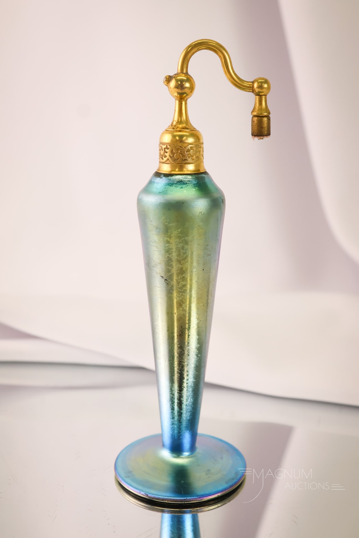 Steuben Blue Aurene Art Glass Perfume Atomizer: A brilliant blue Aurene Steuben perfume atomizer. This piece features the original hardware but is lacking the bulb and cord. The perfume measures 7 1/2" tall.
