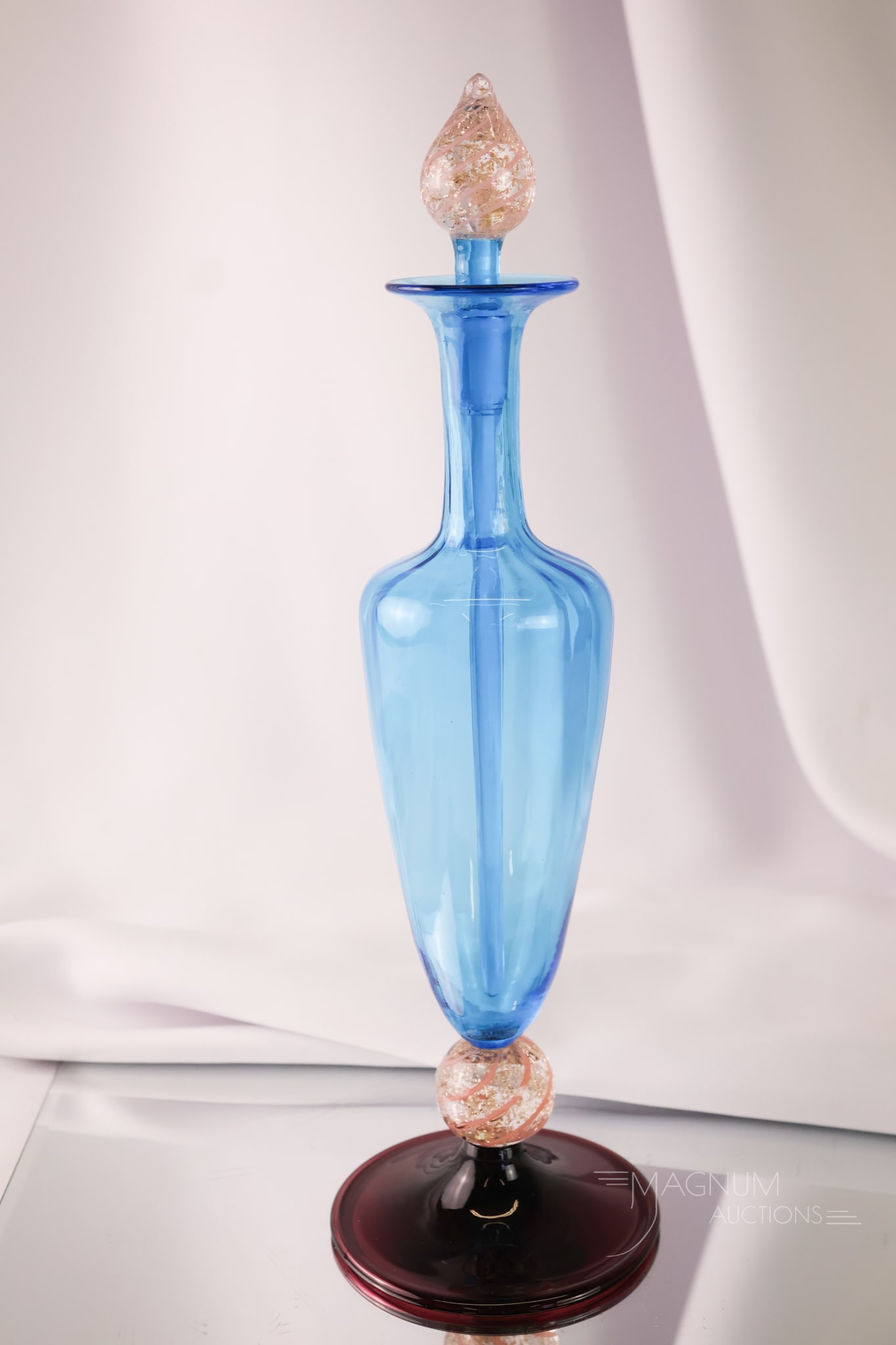 Steuben Celeste Blue Amethyst Cintra Art Glass Perfume Bottle: A wonderful find in a Steuben art glass perfume bottle. This piece is in Celeste blue with a "Cintra" ball standard and matching stopper. The bottle has an amethyst foot. It is signed on the base