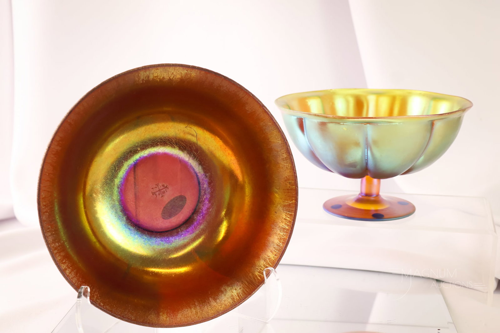 2 pc Lot Iridescent Art Glass Imperial Jewel Line & WMF: Two selections that are sure to sparkle. The first is an Imperial Jewel line bowl. The second is a gold iridescent melon ribbed pedestal bowl by WMF. The tallest measures 3 1/2".