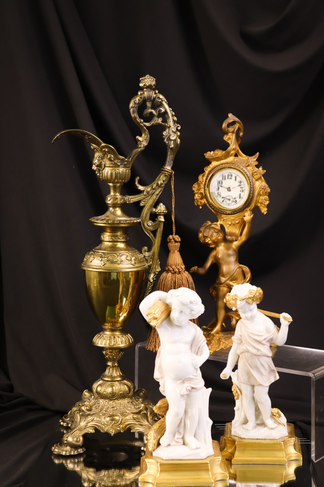4 pc Decorative Arts Brass Ewer Figural Cherub Clock & Italian Porcelain: A select offering of decorative arts pieces for your home and collection. This lot offers an ornate brass ewer. A figural cherub clock. Lastly, there is a pair of Italian porcelain gilt cherub