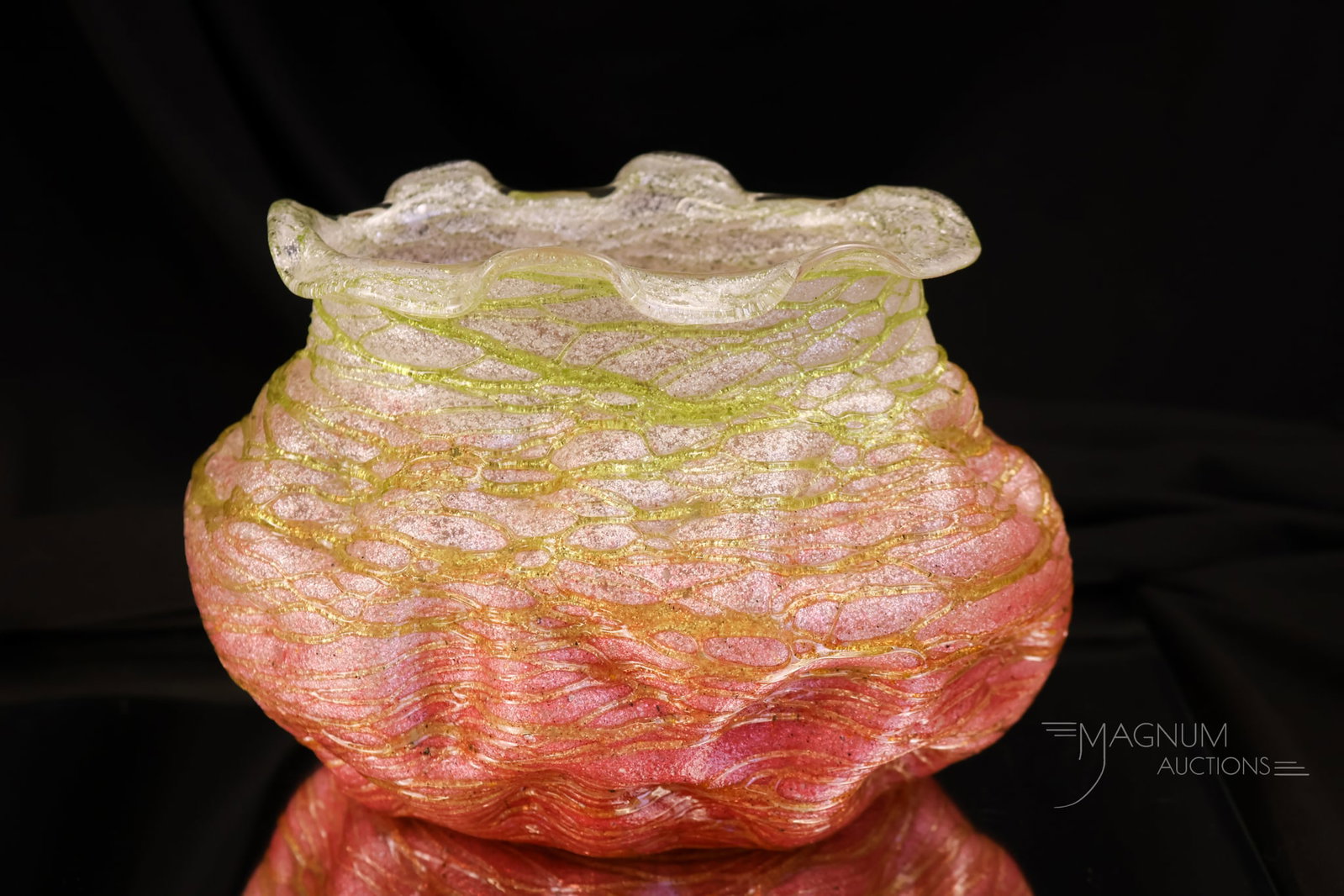 Kralik Silveria Art Nouveau Glass Vase: A striking piece of Kralik Silveria Art Nouveau glass. This piece features a dimpled form with a ruffled rim. It is red to clear with green threading. The vase measures 5" tall.