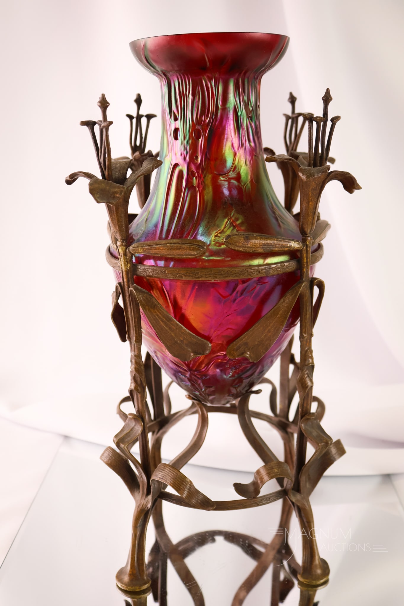 Museum Impressive Kralik Red Iridescent Thistle Jugendstil Bronze Vase: A museum-impressive Kralik Art Nouveau glass vase set in a Jugendstil bronze figural floral holder. The vase is a red iridescent thistle example. It is complete with four flowers with stamens. The pie