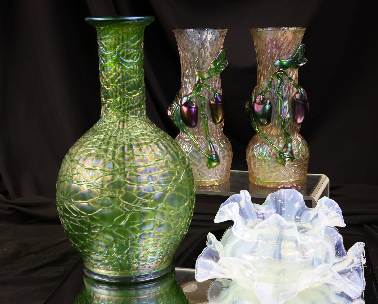 4 pc Lot Art Nouveau Antique Glass Loetz Kralik & More: Four divine finds in antique Art Nouveau glass. The lot includes Loetz, Kralik, and more. There is a matched pair of Kralik Martele vases with applied plums. Each exhibits chips on the rims. The talle