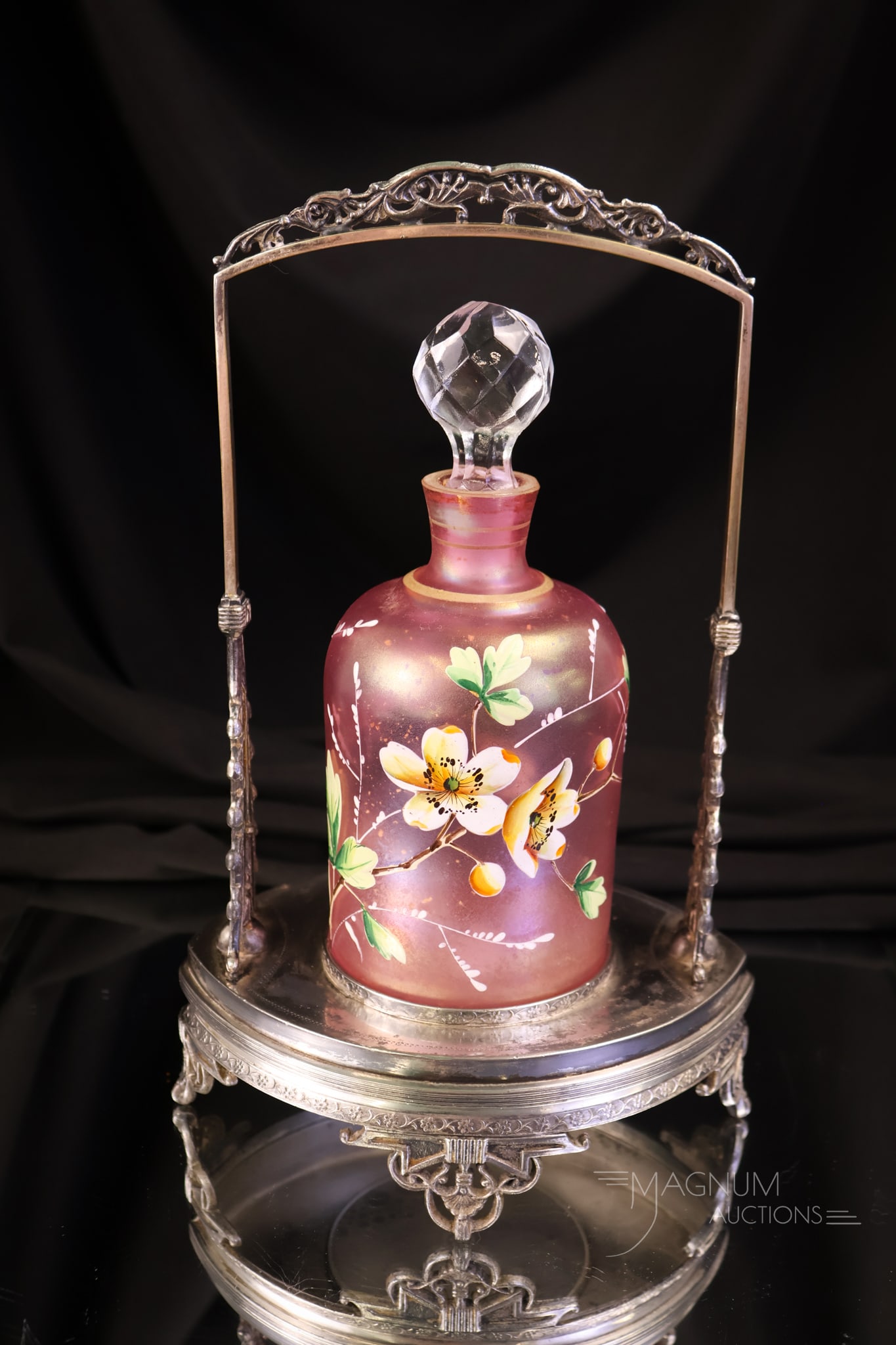 Meriden SilverplateVictorian Pink Iridescent Enamelled Glass Perfume Castor: A beautiful and pretty in pink Victorian silverplate Perfume castor. This piece is marked Meriden. It holds a pink iridescent enamelled glass perfume bottle with florals. This super find measures 10" 