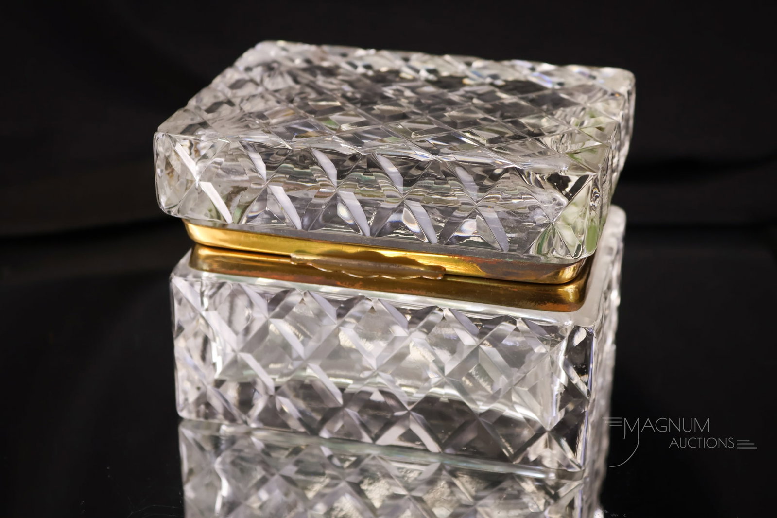 French Cut Crystal Hollywood Regency Jewelry Box: Another sparkling French-cut crystal Hollywood Regency jewelry box. This piece features ormolu mounts. The box measures 3" tall and 4 1/2" wide.