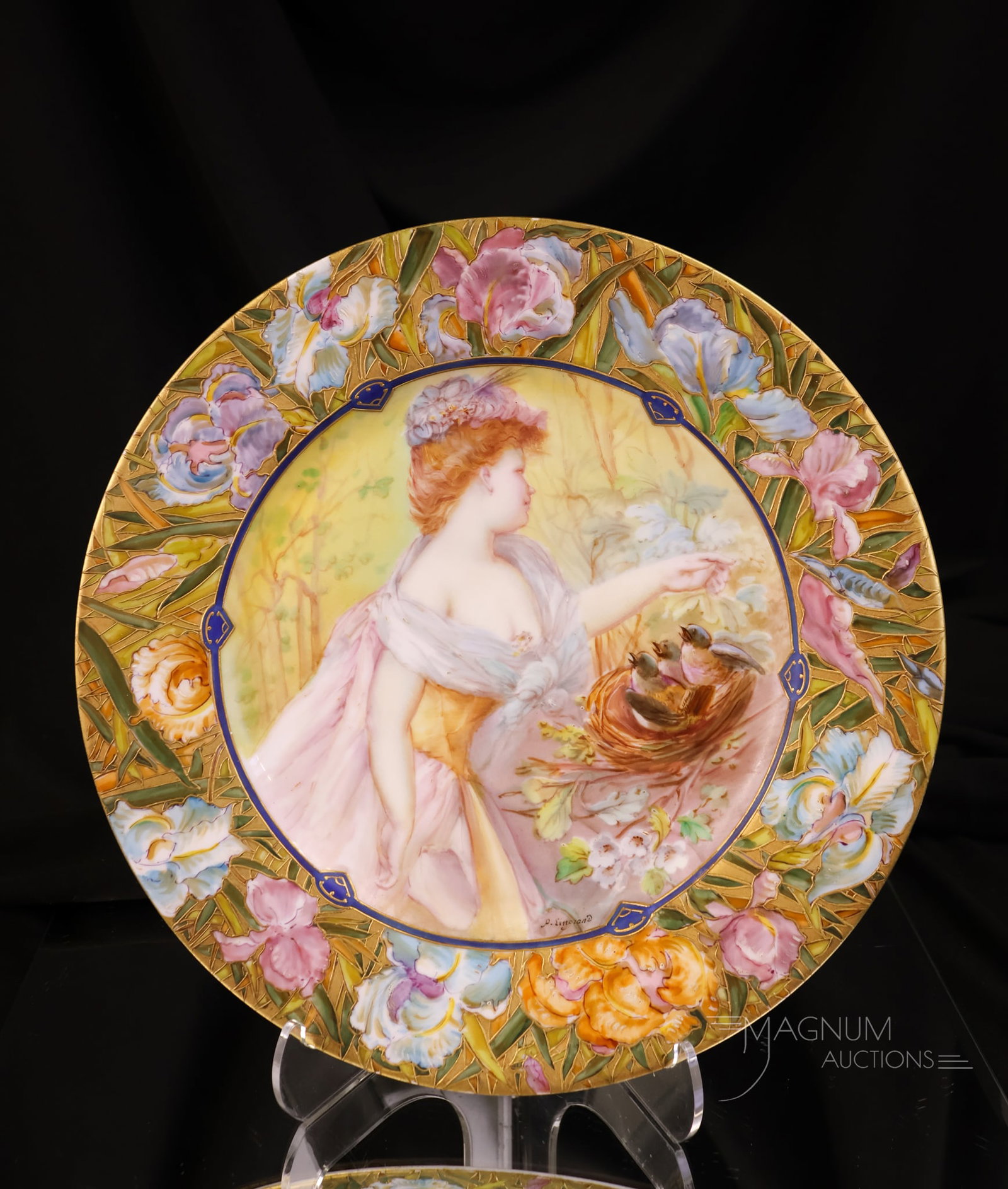 Sevres, France Hand Painted Plate "Lady with Birds in Nest": A lovely find for your collection. This is a Severes France-marked plate. This piece is hand-painted with a lady and birds in a nest and florals. It is further embellished with a gilt rim. The plate m