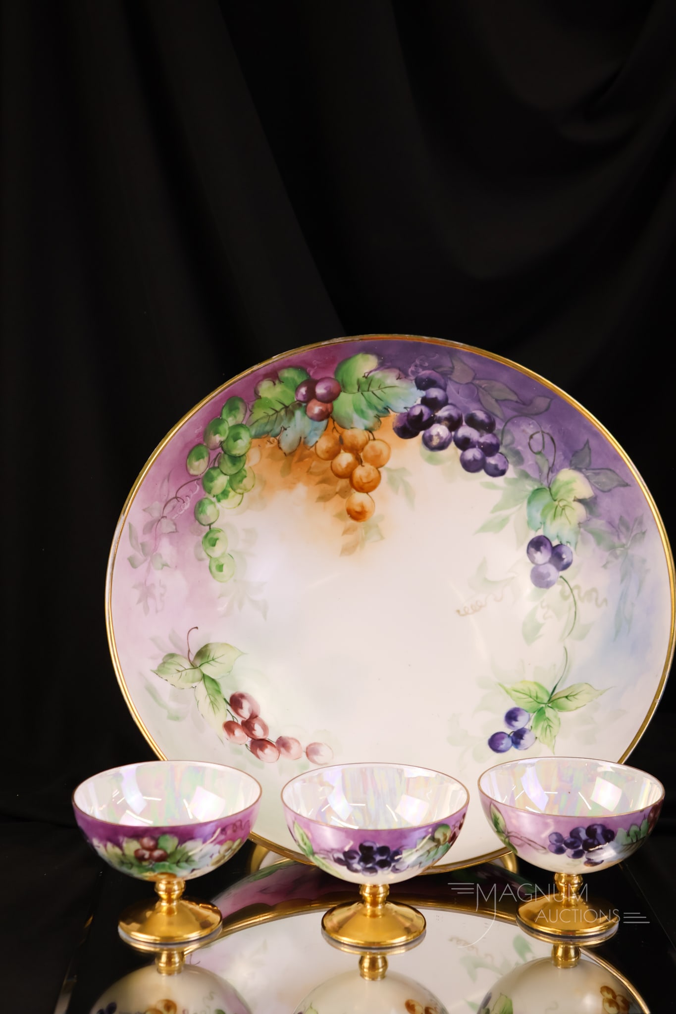 T&V Limoges 4 pc Hand Painted Porcelain Punch Set: A fine T & V Limoges porcelain hand-painted punch set. This set is decorated with succulent, colorful grapes and gold. The offering includes a pedestal punch bowl and three cups. The largest of the se