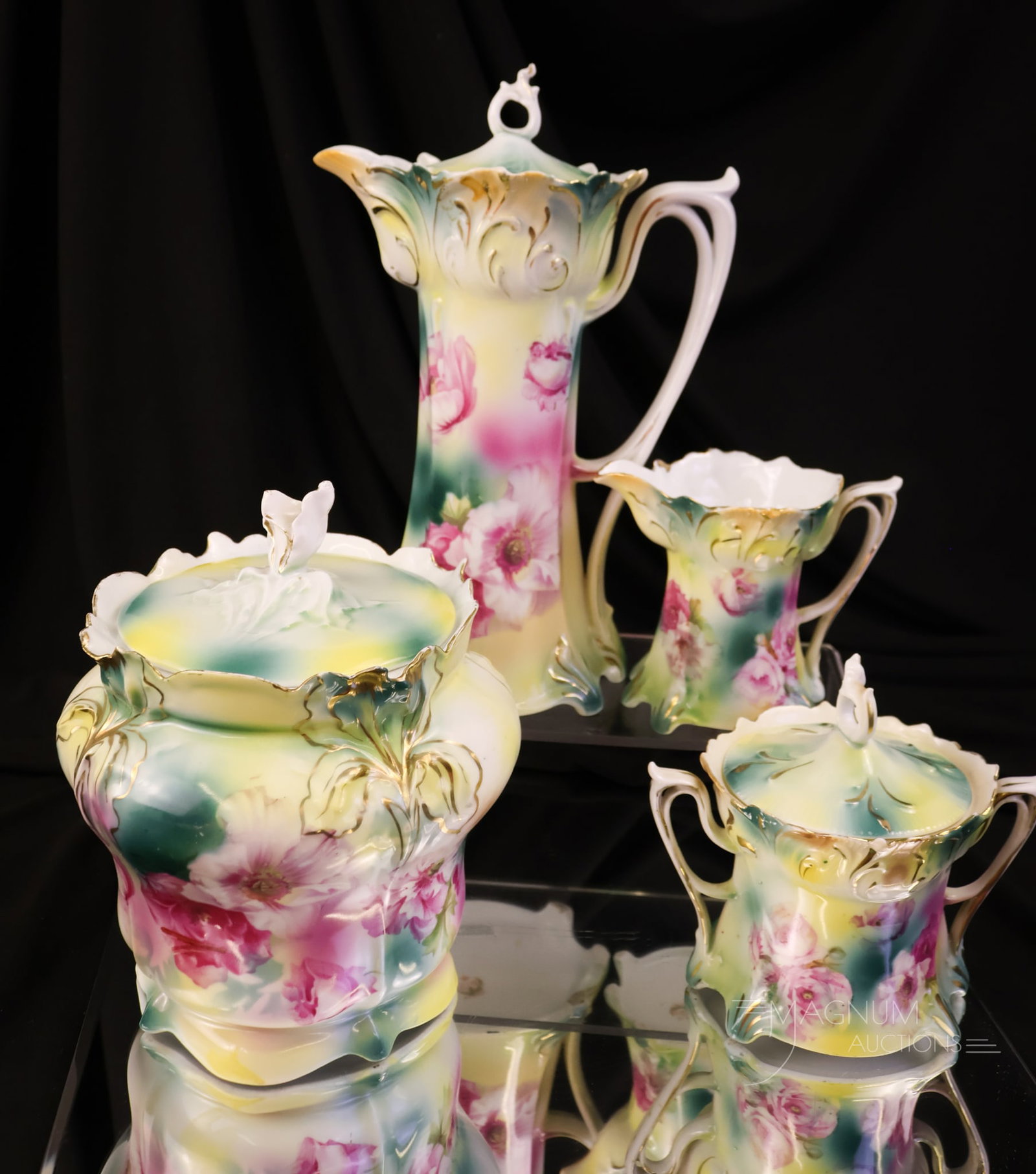 4 pc Lot R.S. Prussia Pink Rose Decorated Porcelain: A select lot of four pieces of pink rose-decorated R.S. Porcelain. This lot offers a teapot, biscuit jar, and a creamer and sugar. The tallest measures 9 1/2".