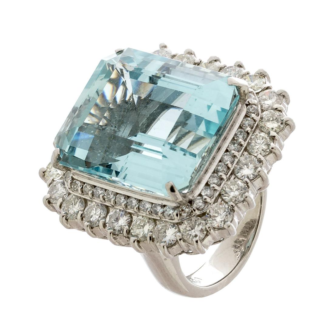 Platinum rosette ring: Platinum rosette ring. With large central aquamarine, emerald cut, of great quality and beauty, good colour and weight ca. 25.00 cts., set in claws and mounted on a beautiful double height structure d