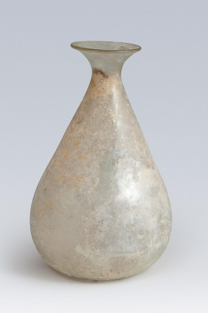 Ointment bottle; Rome, II-III century AD. Glass.: Ointment bottle; Rome, II-III century AD.Glass.Measurements: 13,5 x 8,5 cm.Bottle of Roman origin made of glass that presents a globular and flared body, from which a small and narrow neck, which ends