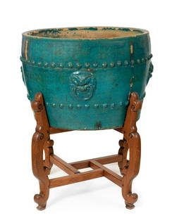 Planter; China, Ming dynasty, 17th century. Glazed ceramic. It presents faults and losses of the: Flower pot; China, Ming dynasty, 17th century. Enamelled ceramic. The glaze is missing and has glaze losses. It has a wooden base. Measurements: 48 x 74 cm; 91 x 77 cm (stand). Large jardiniÃ¨re
