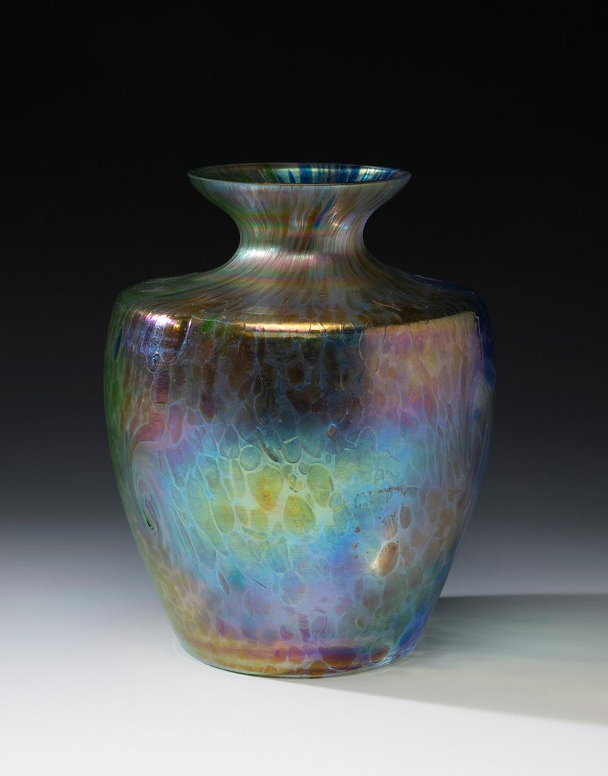 Jugendstil LOETZ vase; Austria, ca. 1900. Iridescent blown glass. An iridescent blown glass vase: Jugendstil LOETZ vase; Austria, ca. 1900. Iridescent blown glass. An iridescent blown glass vase from the Austrian manufacture of Loetz, with a tapering circular body and an open mouth. Papillon" deco