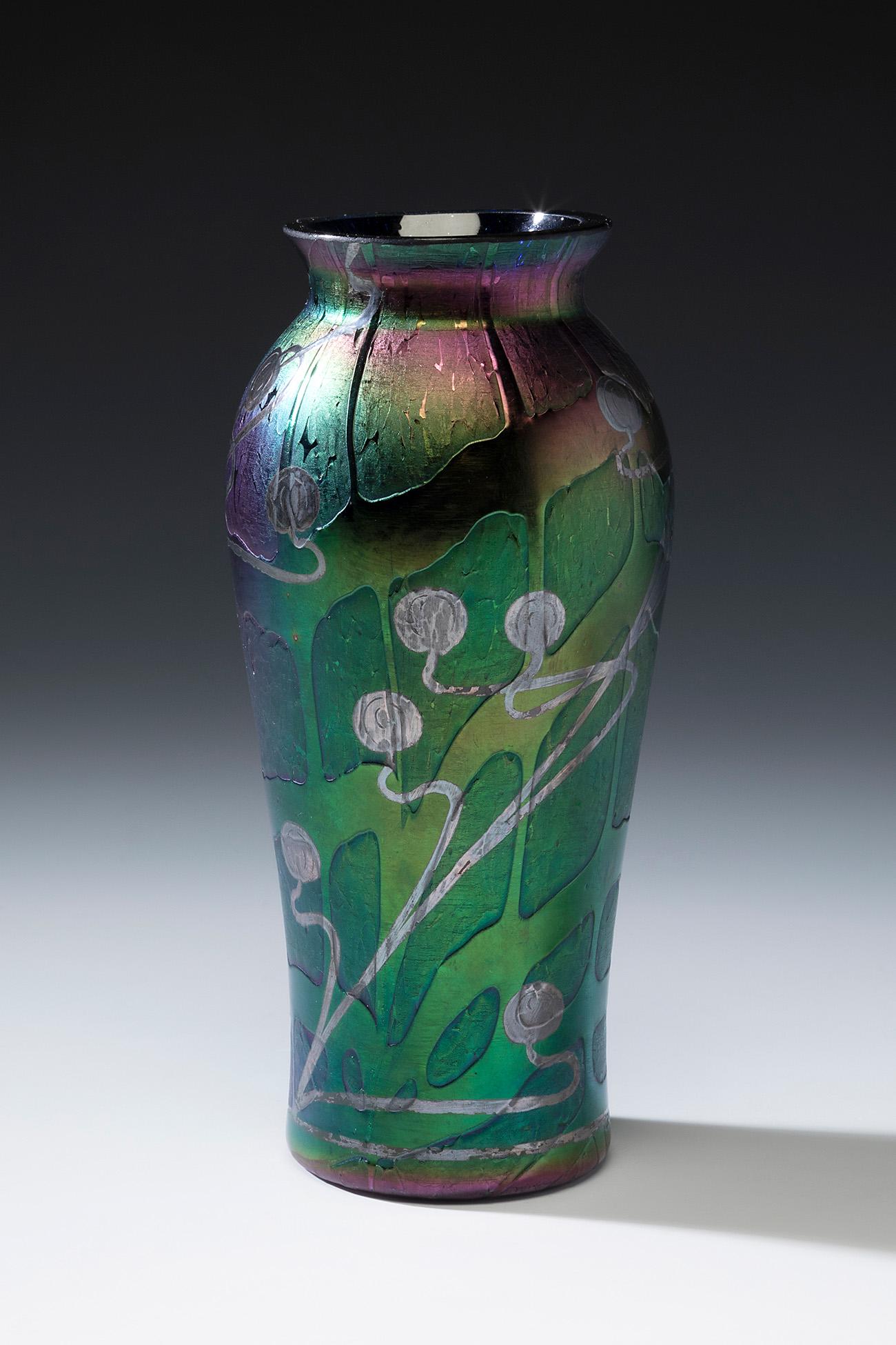Jugendstil LOETZ vase; Austria, ca. 1900. Iridescent blown glass. An iridescent blown glass vase: Jugendstil LOETZ vase; Austria, ca. 1900. Iridescent blown glass. An iridescent blown glass vase from the Austrian Manufacture of Loetz, with a circular body crescent towards the mouth. "Pampas" decor