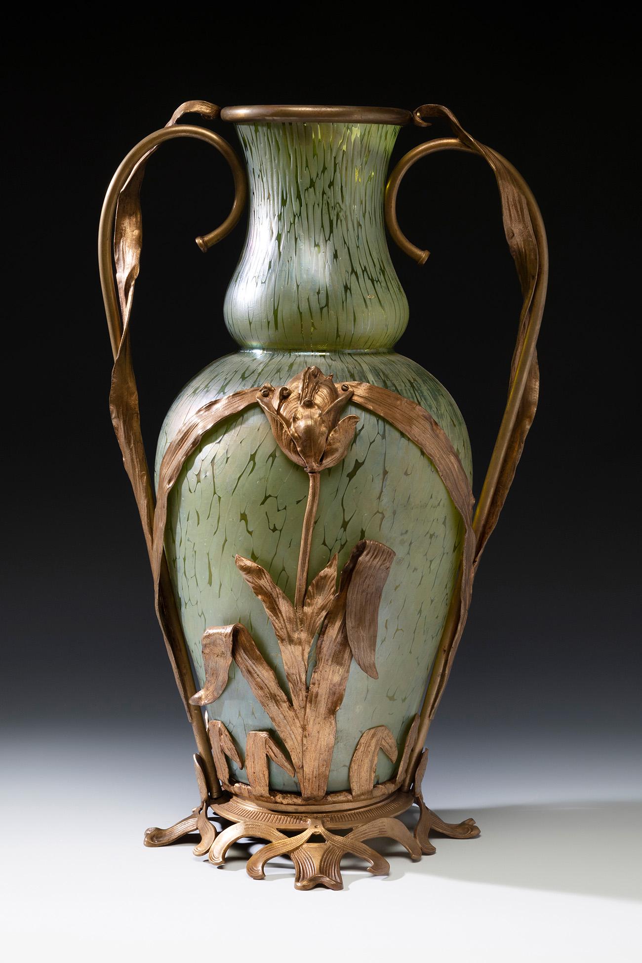 Jugendstil LOETZ vase; Austria, ca. 1895. Iridescent blown glass. An iridescent blown glass vase: Jugendstil LOETZ vase; Austria, ca. 1895. Iridescent blown glass. An iridescent blown glass vase from the Austrian manufacture of Loetz, with "Papillon" decoration in shades of green. Decorated in rel