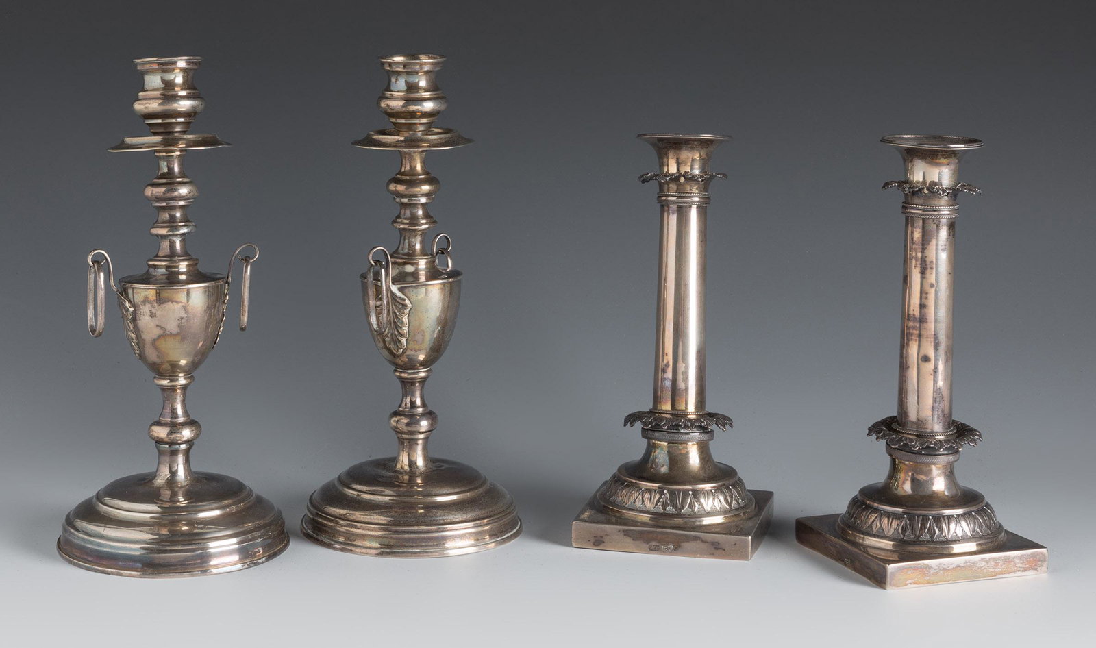 Two pairs of French style candlesticks, late 19th century. Silver. Some dents.  Initials engraved on (1 of 6)