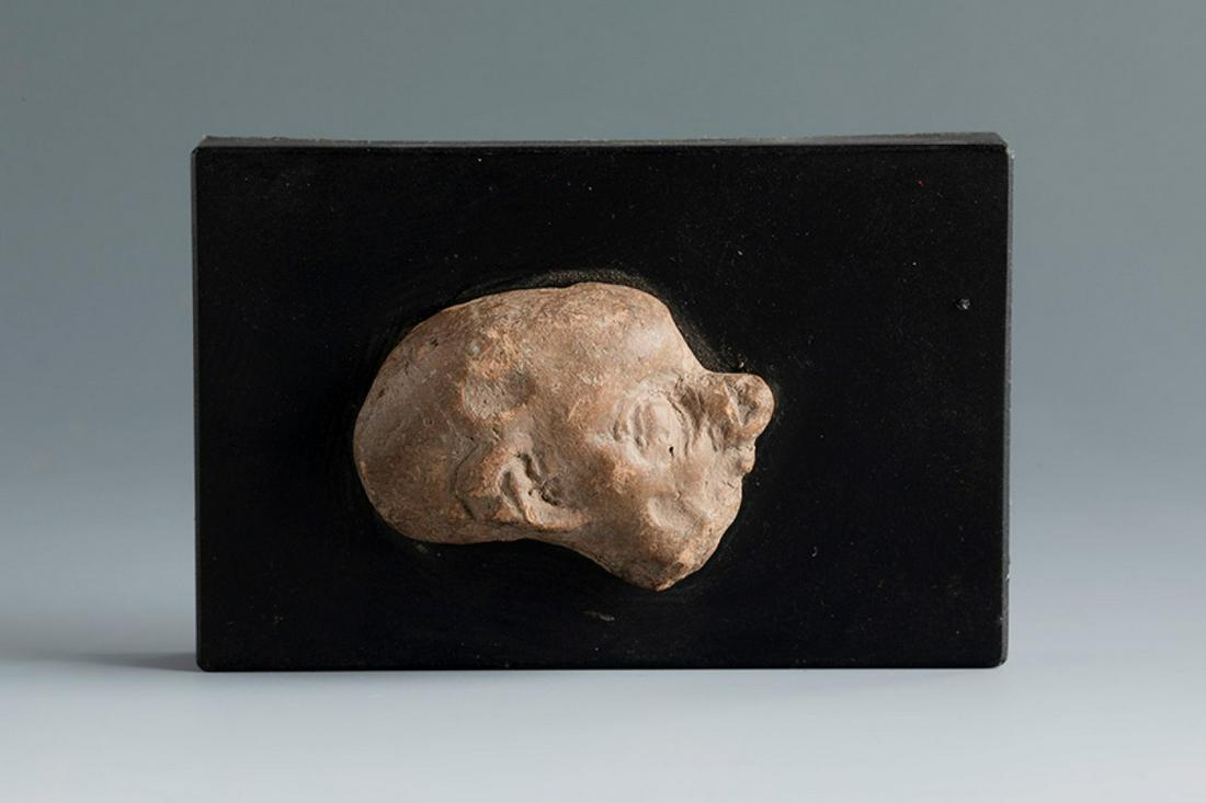 Grotesque head in profile. Smyrna, 3rd century BC. Terracotta. Provenance: Smyrna, 1895-1905.: Grotesque head in profile. Smyrna, 3rd century BC. Terracotta. Provenance: Smyrna, 1895-1905. Collection Paul Gaudin (Paris 1858-1921 Versailles), archaeologist, engineer and great patron of the Louvr