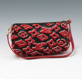 LOUIS VUITTON. Red URS Fisher pochette bag. Black leather with red monograms. Short handle in red: LOUIS VUITTON. Red x Urs Fischer pochette bag, 2021 season. Black leather with red monograms. Short handle in red leather. Accompanied by its dust bag. Black interior. Zip fastener. In good