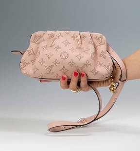 LOUIS VUITTON. Pochette Scala Pouch Mini Perforated.: LOUIS VUITTON. Pochette Scala Pouch Mini Perforated. In Mahina perforated calfskin in magnolia pink. Calfskin trim. Microfiber lining. Silver hardware. Zipper closure. Flat interior bag. Strap: remova