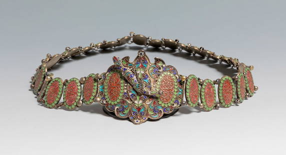 A Russian belt, 19th Century. Gilted and cliosonne-enamel silver belt with engraving and foliate: A Russian belt, 19th Century. Gilted and cliosonne-enamel silver belt with engraving and foliate scroll decoration, lock shaped as a dagger with safety chain, with 30 oval links each connected with sm