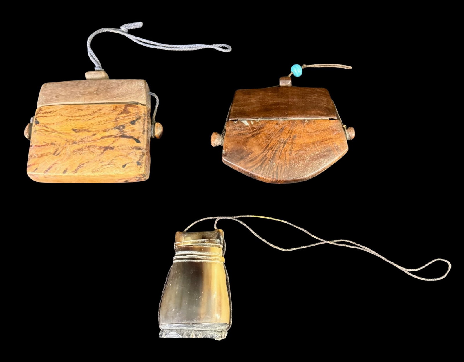 Vintage Indonesian Tongal Boxes: These vintage tongal boxes were used to hold money, tobacco, or small valuable possessions. Two are carved from local exotic hardwoods, and one is made from horn. They are most likely from Sumba Islan