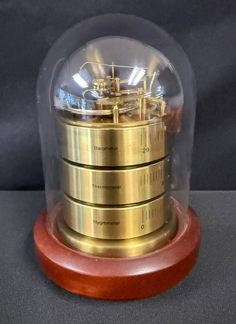 Vintage Barigo Mechanical Dome Weather Station: This vintage Barigo multi-instrument mechanical dome weather station combines three separate analog gauges stacked vertically inside a cylindrical glass dome: a barometer, a thermometer, and a hygrome