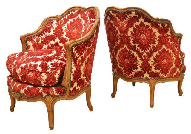 FRENCH LOUIS XV STYLE FRUITWOOD BERGERES: (lot of 2) French Louis XV style armchairs, 20th c., fruitwood frame, damask patterned upholstery, tack trim, loose seat cushion, rising on cabriole legs, approx 32"h, 25.25"w, 27"d, seat height