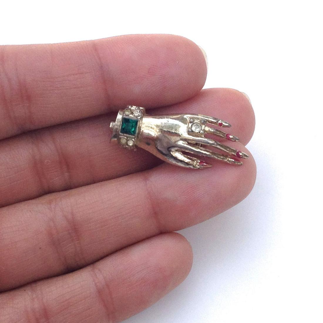 CORO Vintage gold tone Hand with Ring brooch, signed: CORO: Vintage gold tone Hand with Ring and red enamel nails brooch, signed. Hallmarked Coro. Measured 1 3/4 x 1/2 inches. Condition very good.