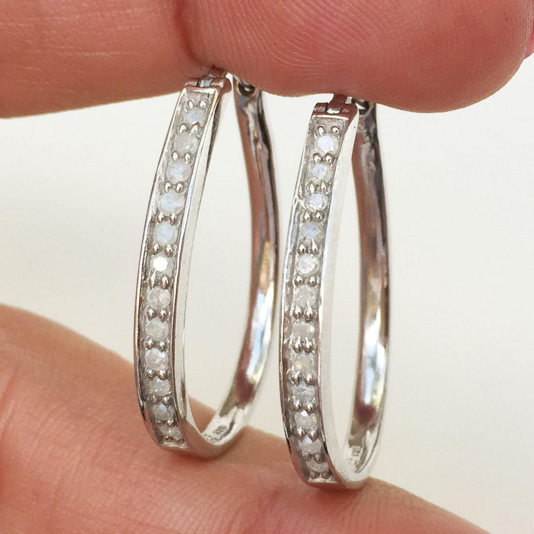 Sterling silver diamond oval hoop latch back earrings: Sterling silver diamond oval hoop latch back earrings. Weight 3.81 grams. Hallmarked 925. Length 1 1/8 inches. Condition excellent.