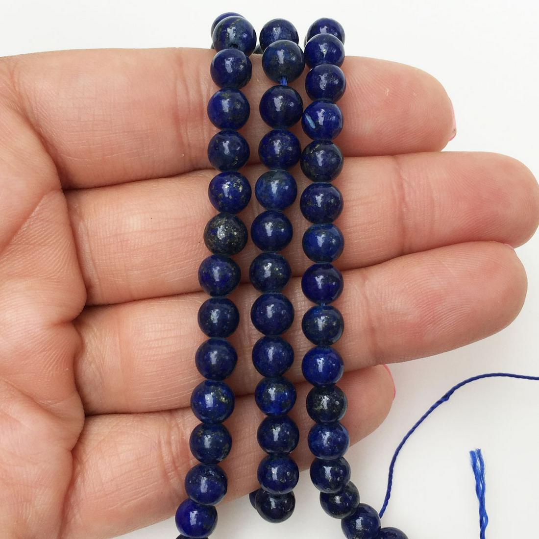6 mm round shape Lapis Lazuli beads strand: 6 mm round shape Lapis Lazuli beads strand. Length 15 1/4 inches. Lapis has vivid color with natural discolorations and gold flecks.