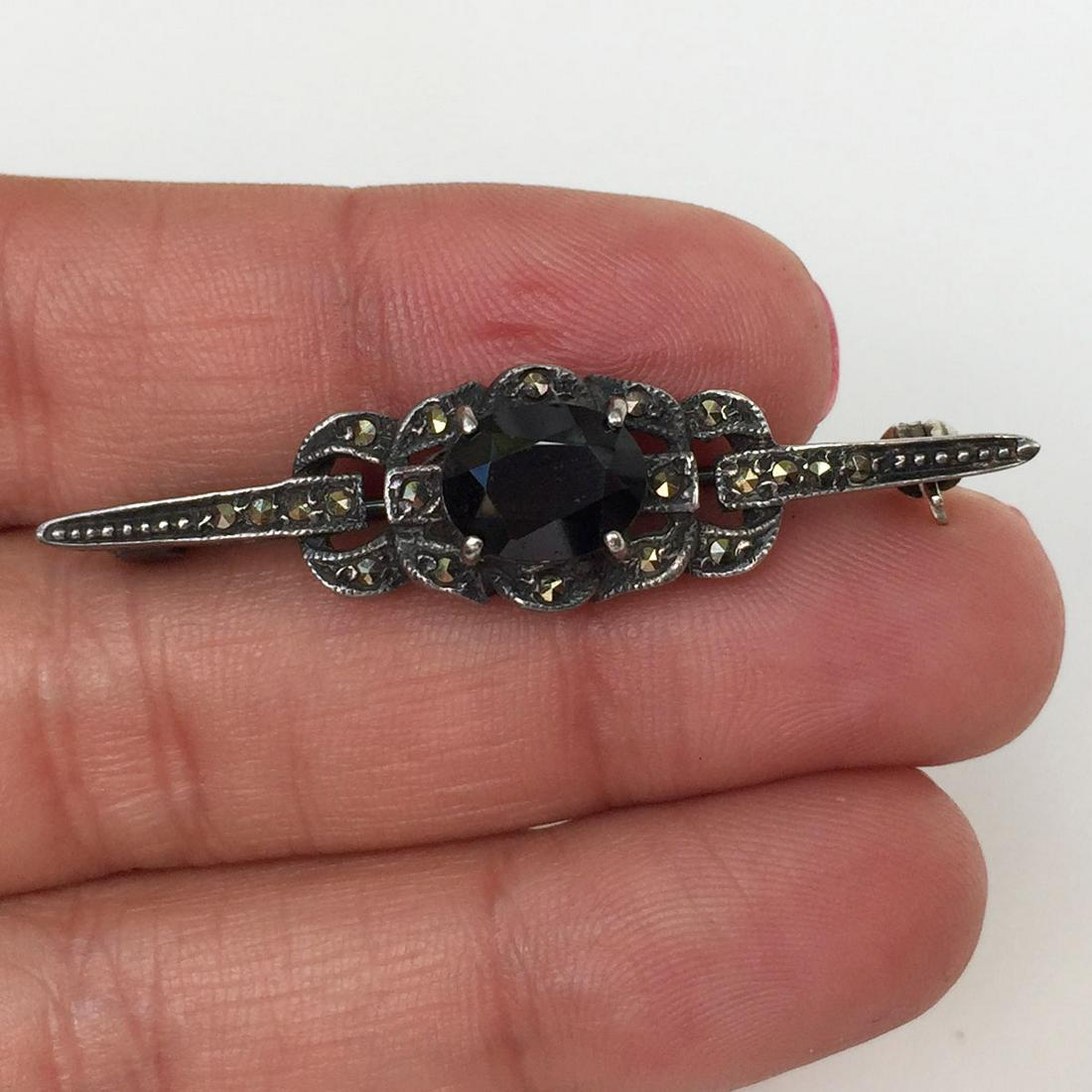 Vintage sterling silver black crystal marcasites brooch: Vintage sterling silver oval black crystal marcasites brooch. Weight 5.16 grams. No hallmark, tested 925. Measured 1 7/8 x 3/8 inches. Condition very good.