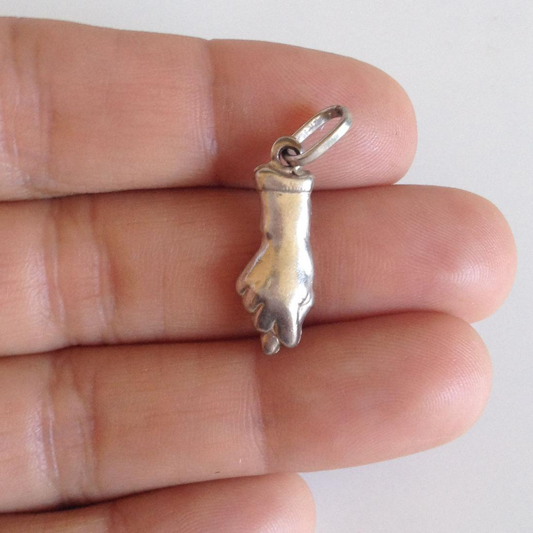 Sterling silver Fig Hand Sign pendant charm: Sterling silver Fig Hand Sign pendant charm. Weight 1.39 grams. Hallmark 925. Length 1 1/8 inches with bail. Condition excellent.