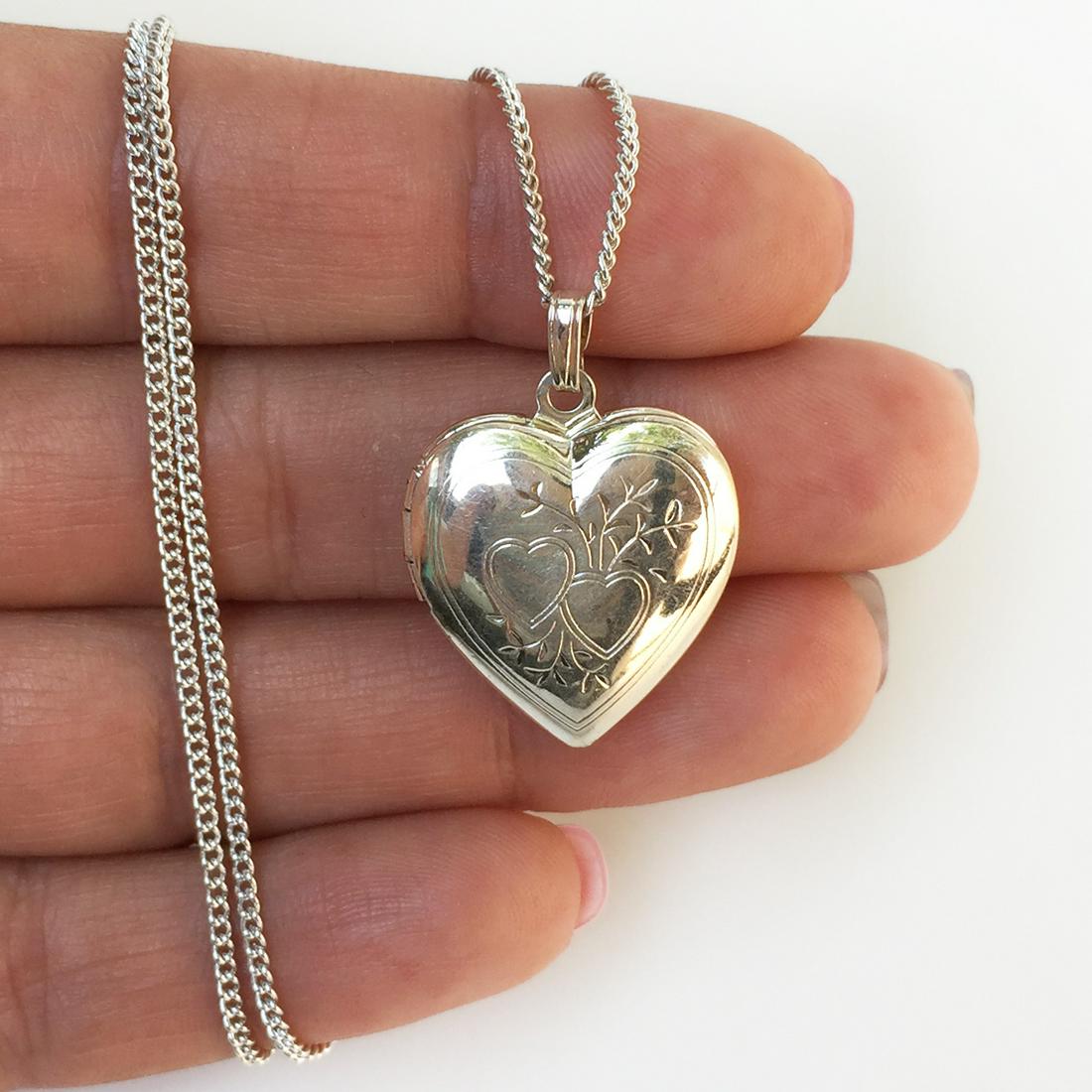 Silver tone Heart shape locket and chain necklace: Silver tone Heart shape locket and chain necklace. Pendant length 1 1/8 inches with bail. Chain length 18 inches + 1 inch extender. Condition very good.