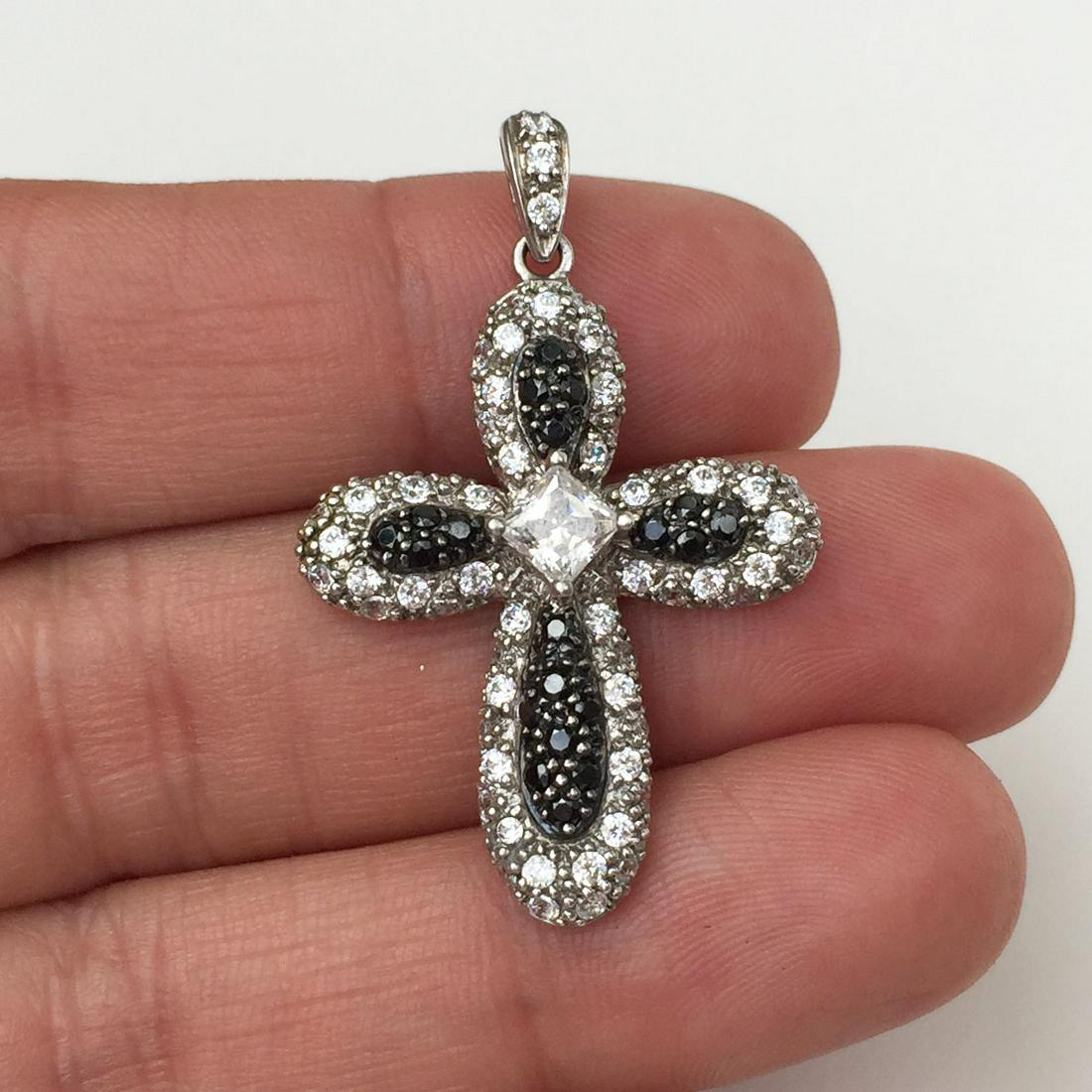 Sterling silver CZ black crystals Cross pendant: Sterling silver CZ black crystals Cross pendant. Weight 3.68 grams. Hallmarked MEDA 925 China. Length 1 1/2 inches with bail. Condition excellent.