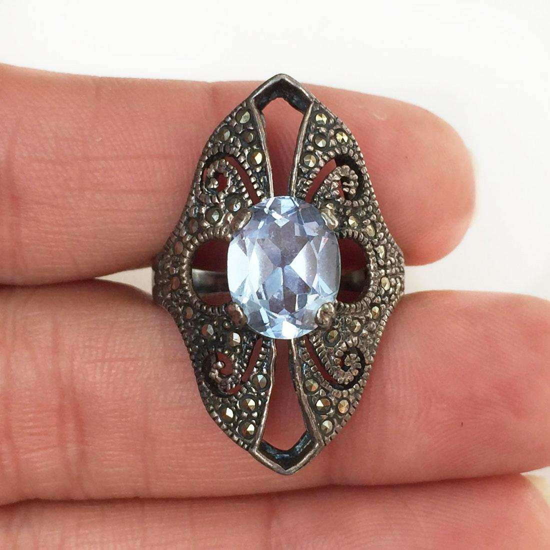 Vintage sterling silver sky blue topaz cocktail ring: Vintage sterling silver oval faceted sky blue topaz marcasites cocktail ring. Ring size 7.25. Weight 6.18 grams. Hallmarked 925. Top measured 1 1/4 x 5/8 inches. Condition very good.