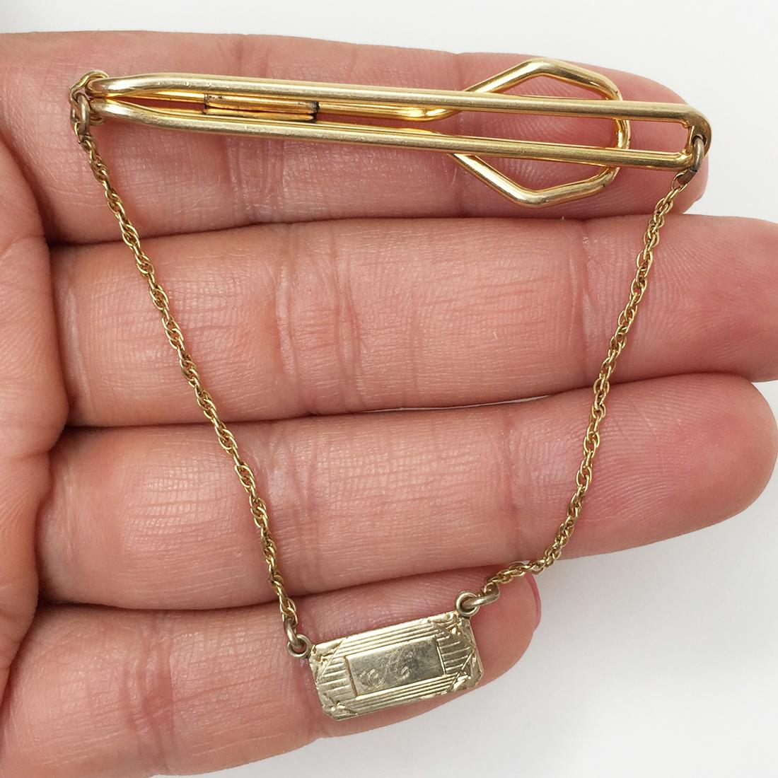 Vintage 12k Gold filled Letter A plate chain tie bar: Vintage 12k Gold filled Letter A plate chain tie bar. Hallmarked 1/20 12KT G.F. and a mountain or animal face logo. Letter Initial A engraved on the dangling plate. Clip length 2 1/8 inches. Condition