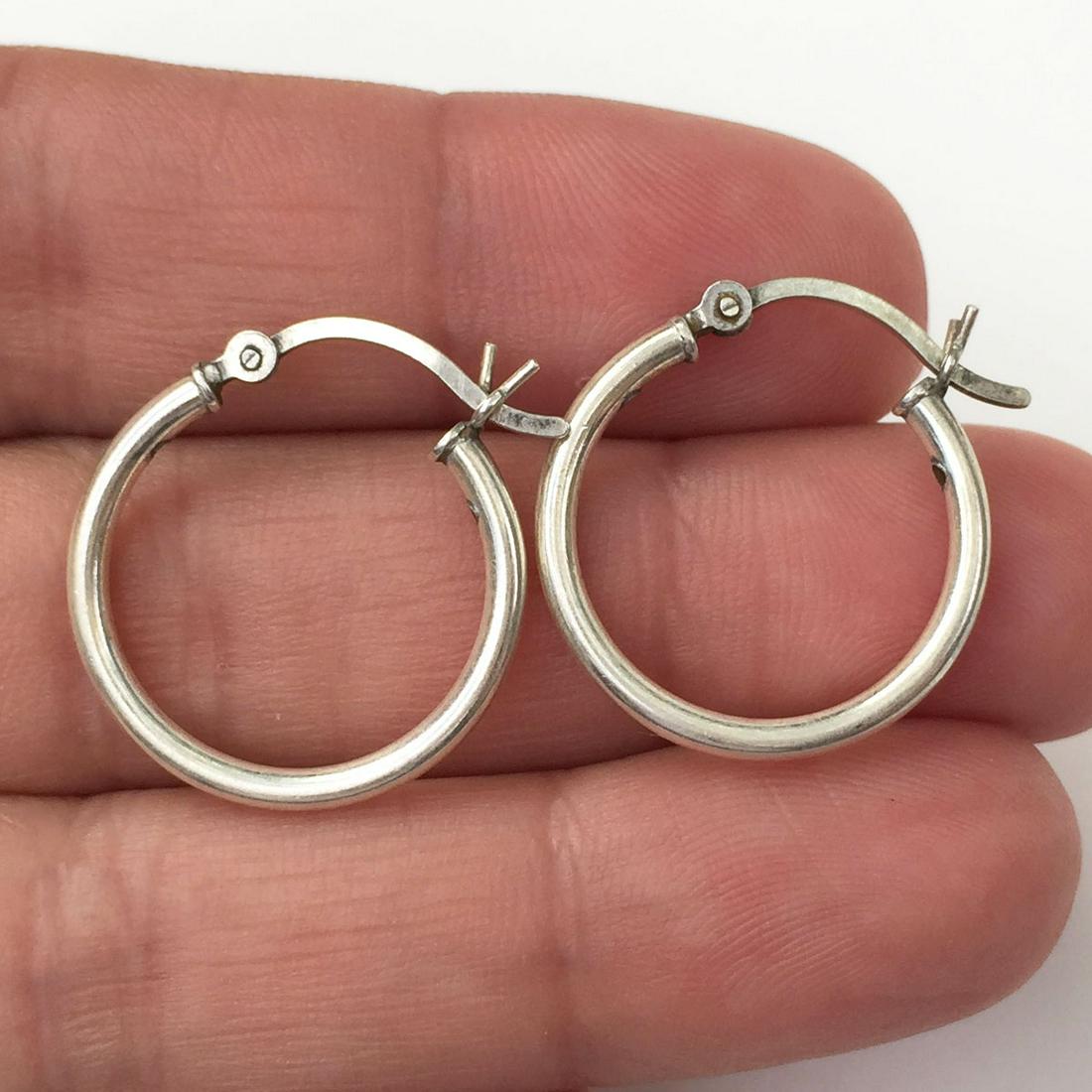 Sterling silver hoop latch back earrings: Sterling silver hoop latch back earrings. Weight 1.80 grams. Hallmarked 925. Length 7/8 inches. Condition excellent.